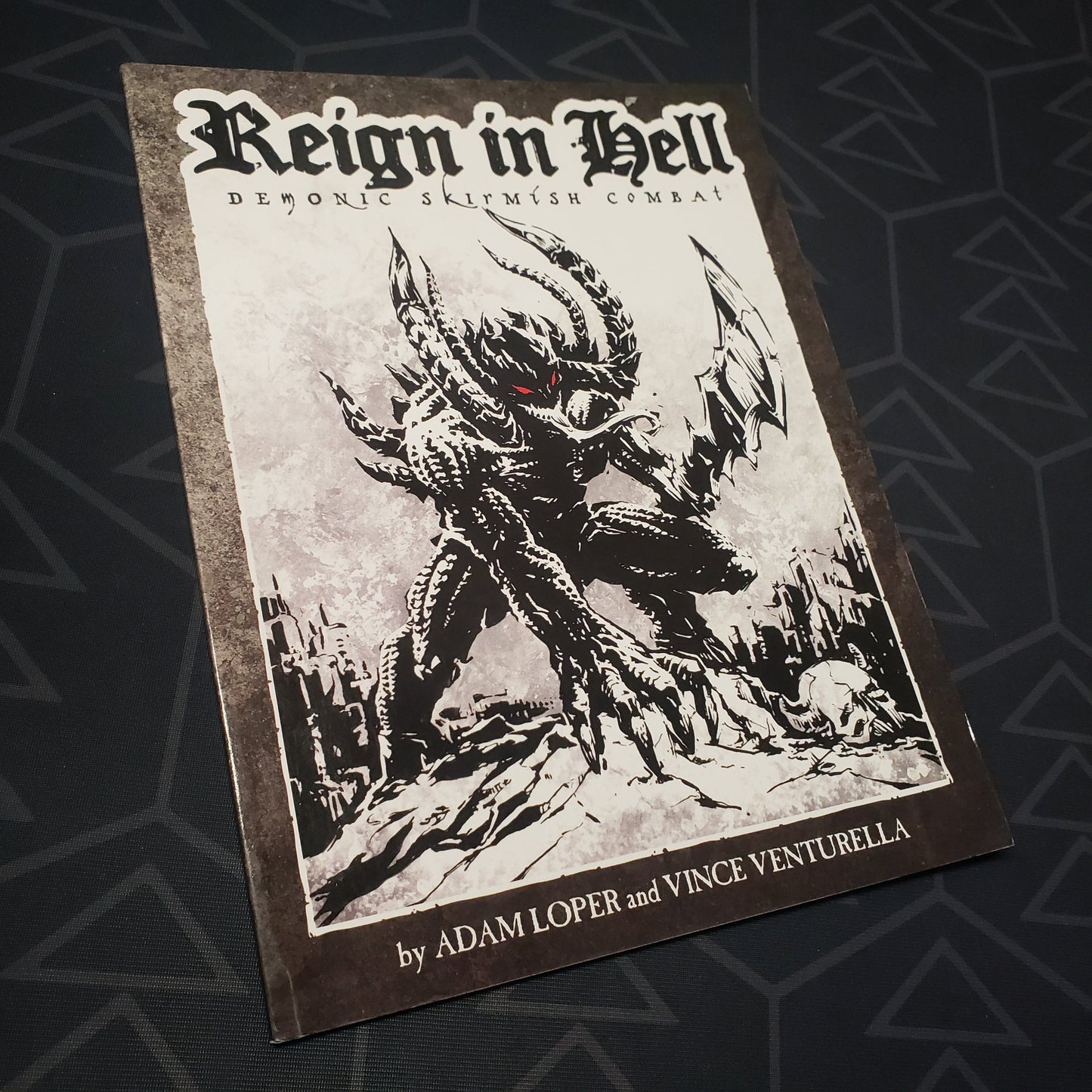 Image shows the front cover of the Reign in Hell: Demonic Skirmish Game wargaming book