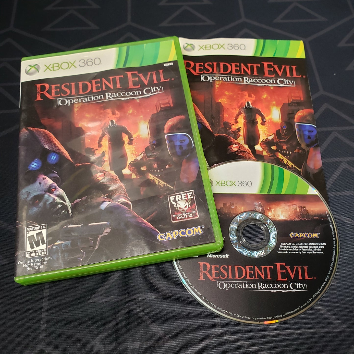 Image shows the case, manual & disc for the video game Resident Evil: Operation Raccoon City for Xbox 360