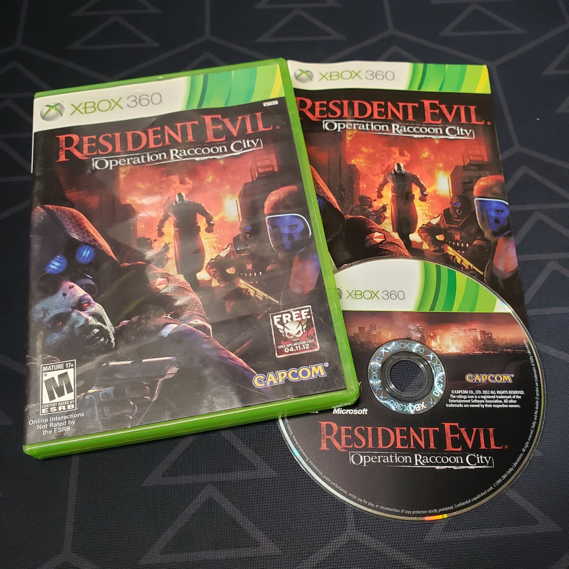 Image shows the case, manual & disc for the video game Resident Evil: Operation Raccoon City for Xbox 360