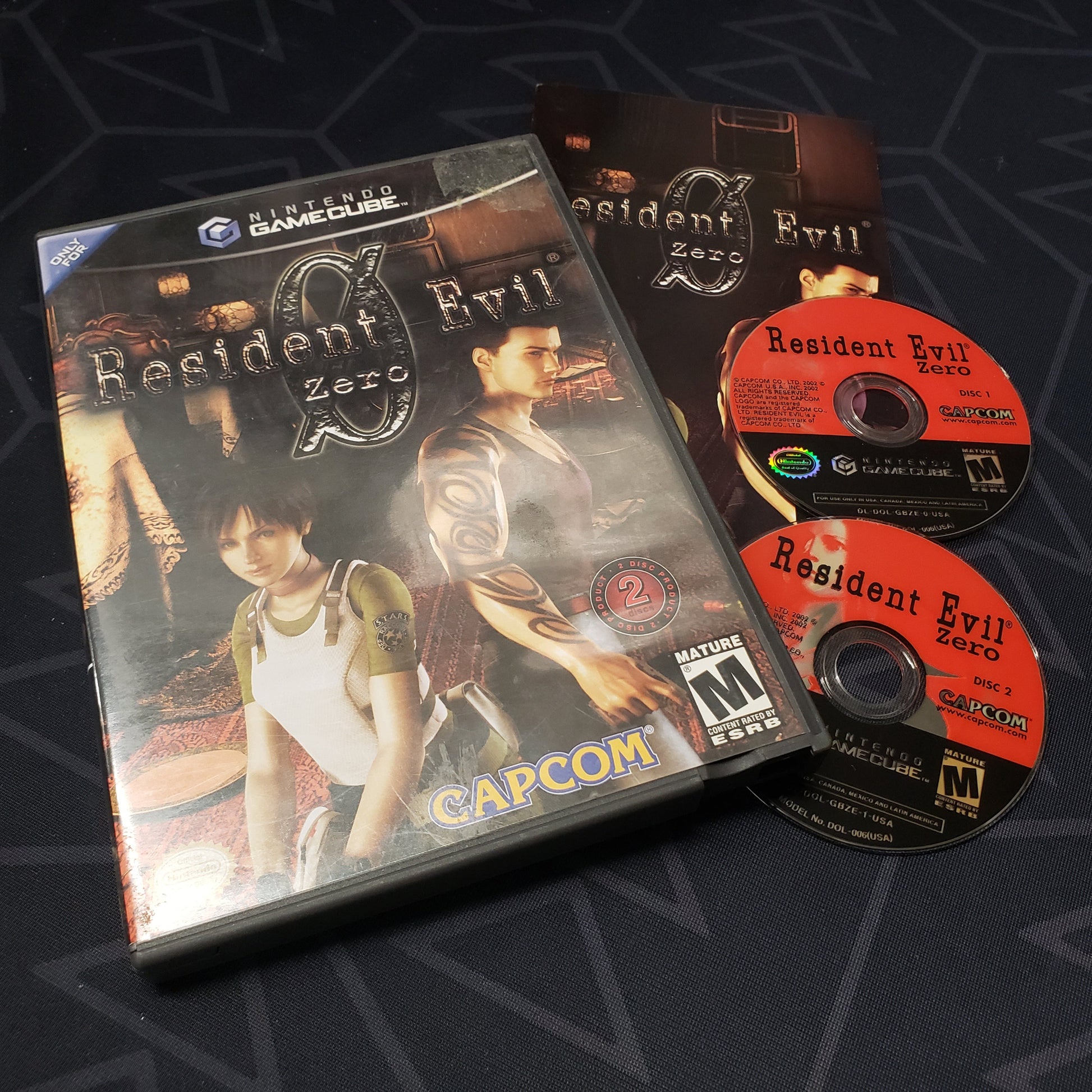 Image shows the case, manual and two discs for the video game Resident Evil Zero  for Nintendo GameCube