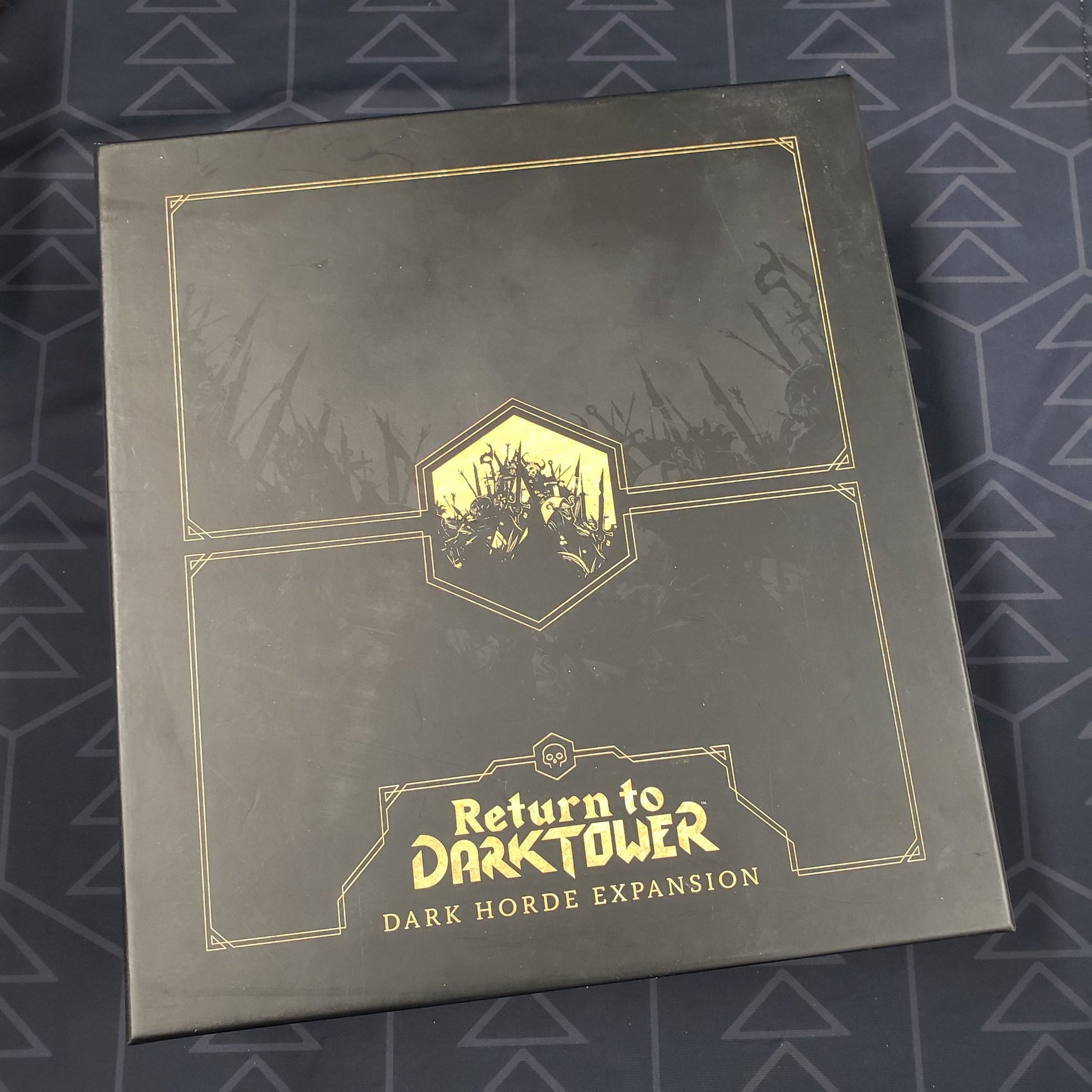 Image shows the front cover of the box of the Dark Horde expansion for the board game Return to Dark Tower