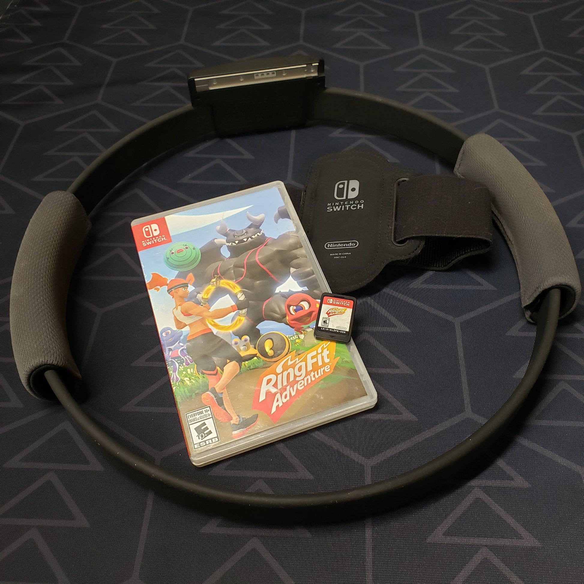 Image shows the case, cartridge and workout accessories for the video game Ring Fit Adventure for Nintendo Switch
