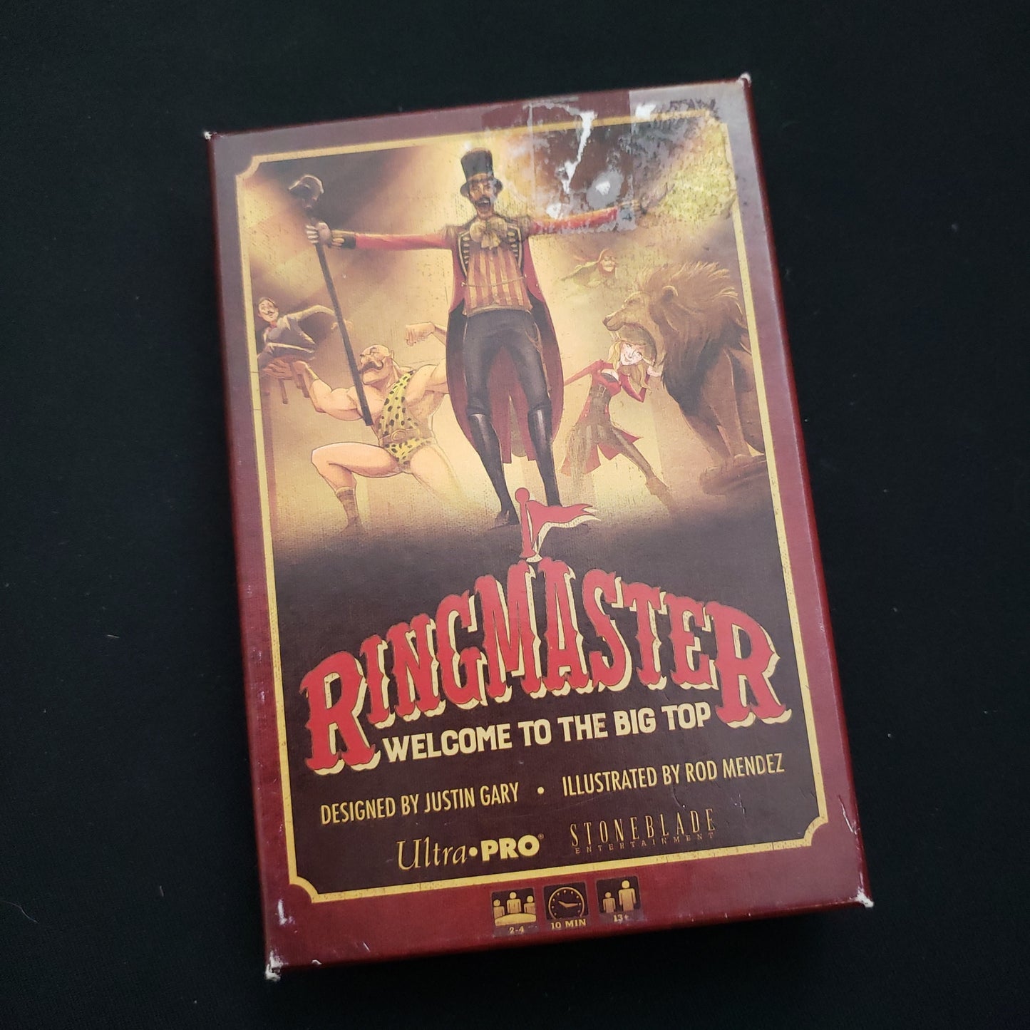 Image shows the front cover of the box of the Ringmaster: Welcome to the Big Top card game