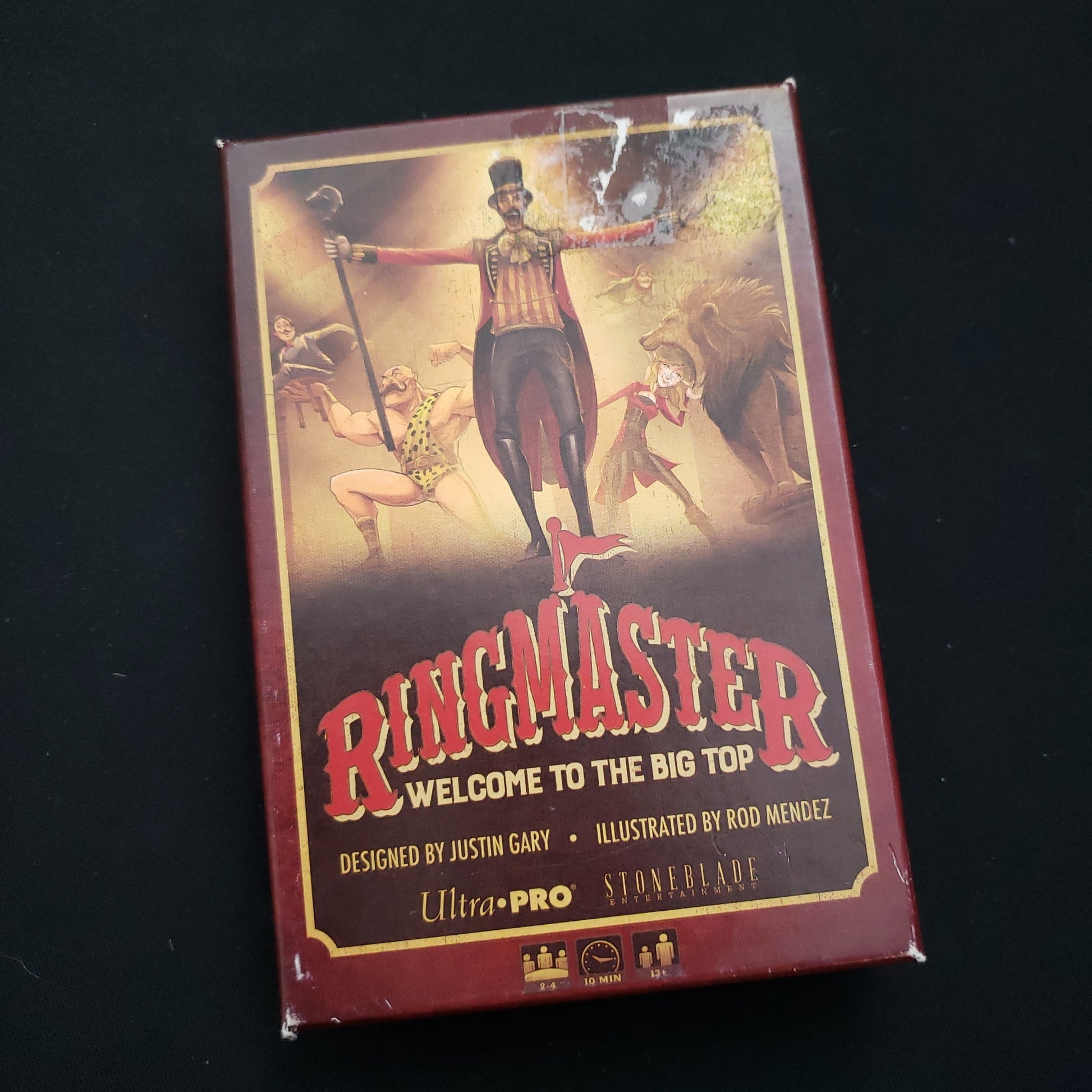 Image shows the front cover of the box of the Ringmaster: Welcome to the Big Top card game