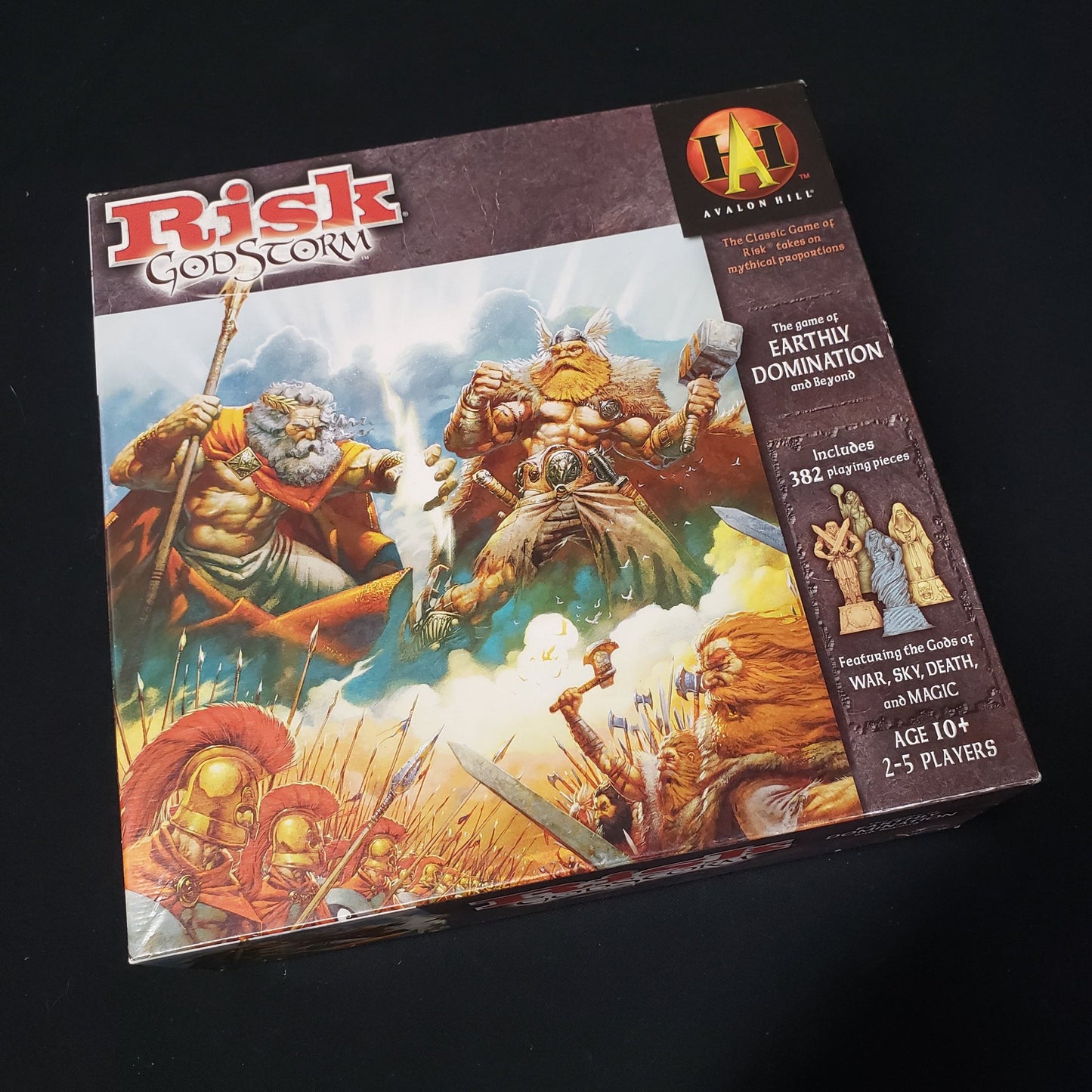 Image shows the front cover of the box of the Risk: Godstorm board game