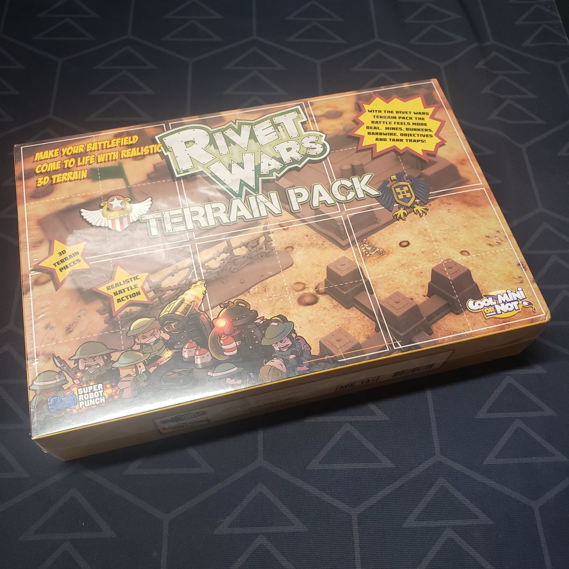 Image shows the front cover of the box of the Terrain Pack expansion for the board game Rivet Wars