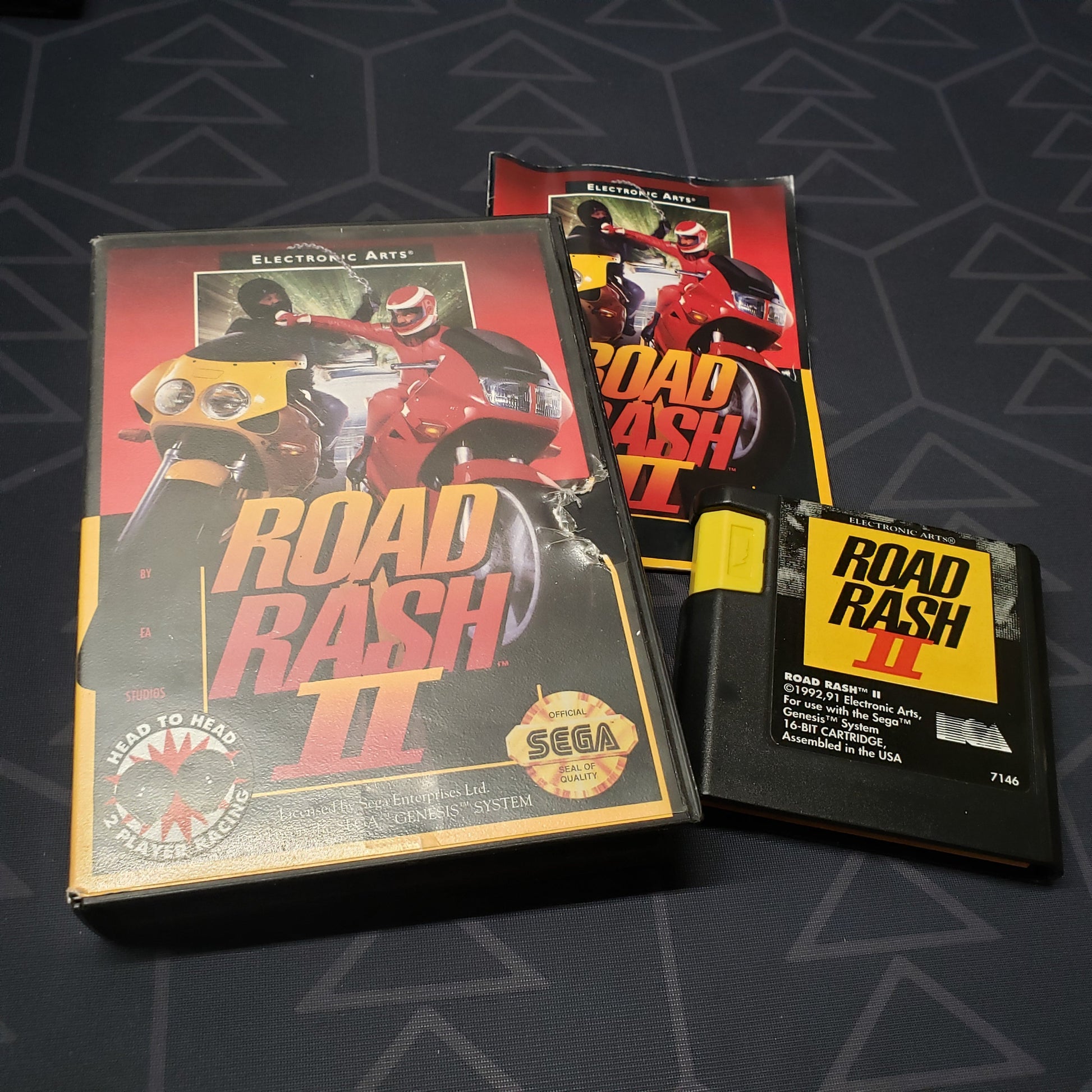 Image shows the case, manual and cartridge for the video game Road Rash II for Sega Genesis