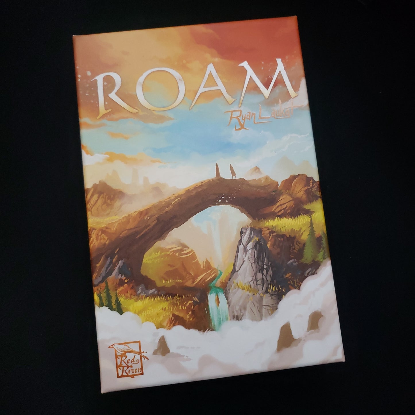 Image shows the front cover of the box of the Roam board game