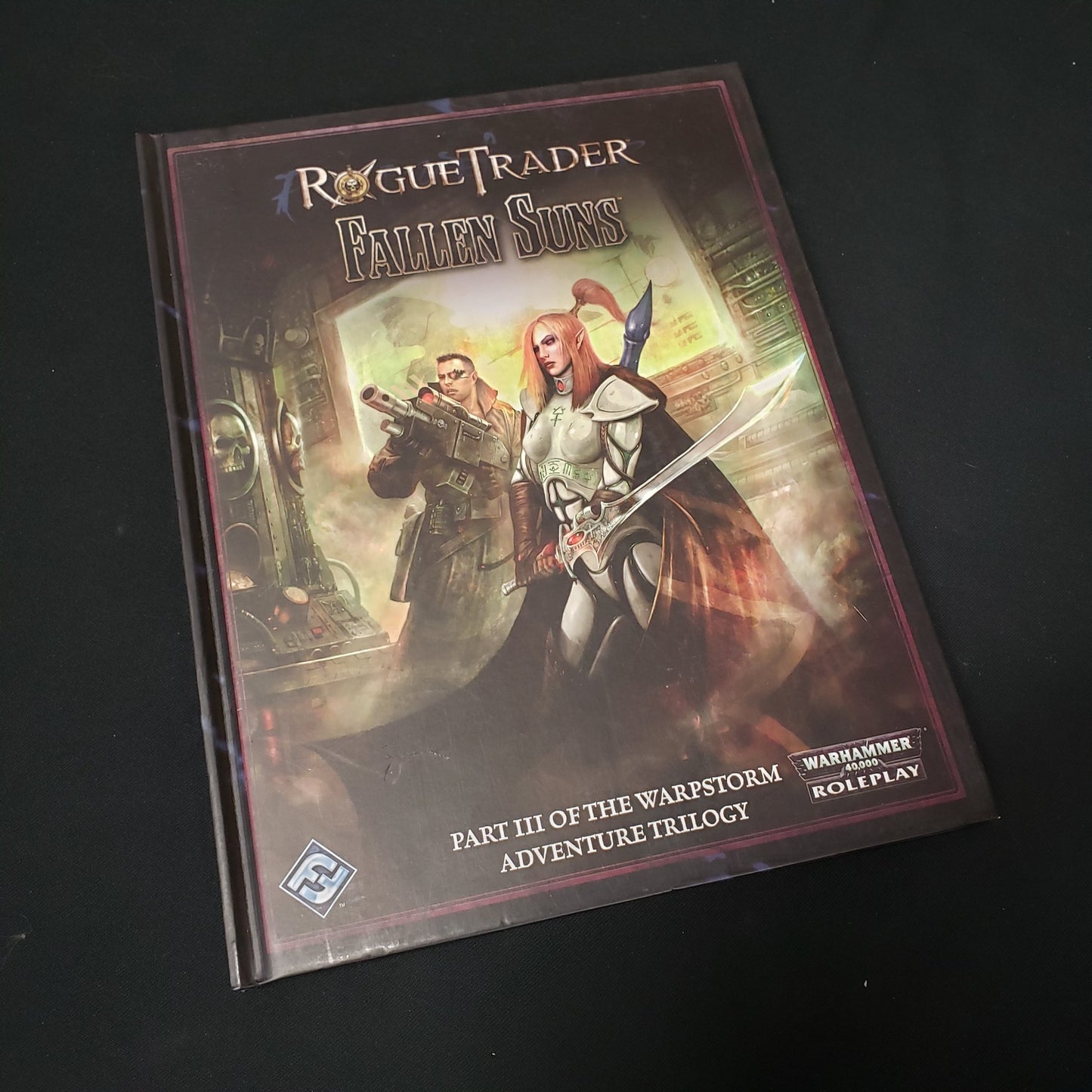 Image shows the front cover of the Fallen Suns book for the roleplaying game Rogue Trader