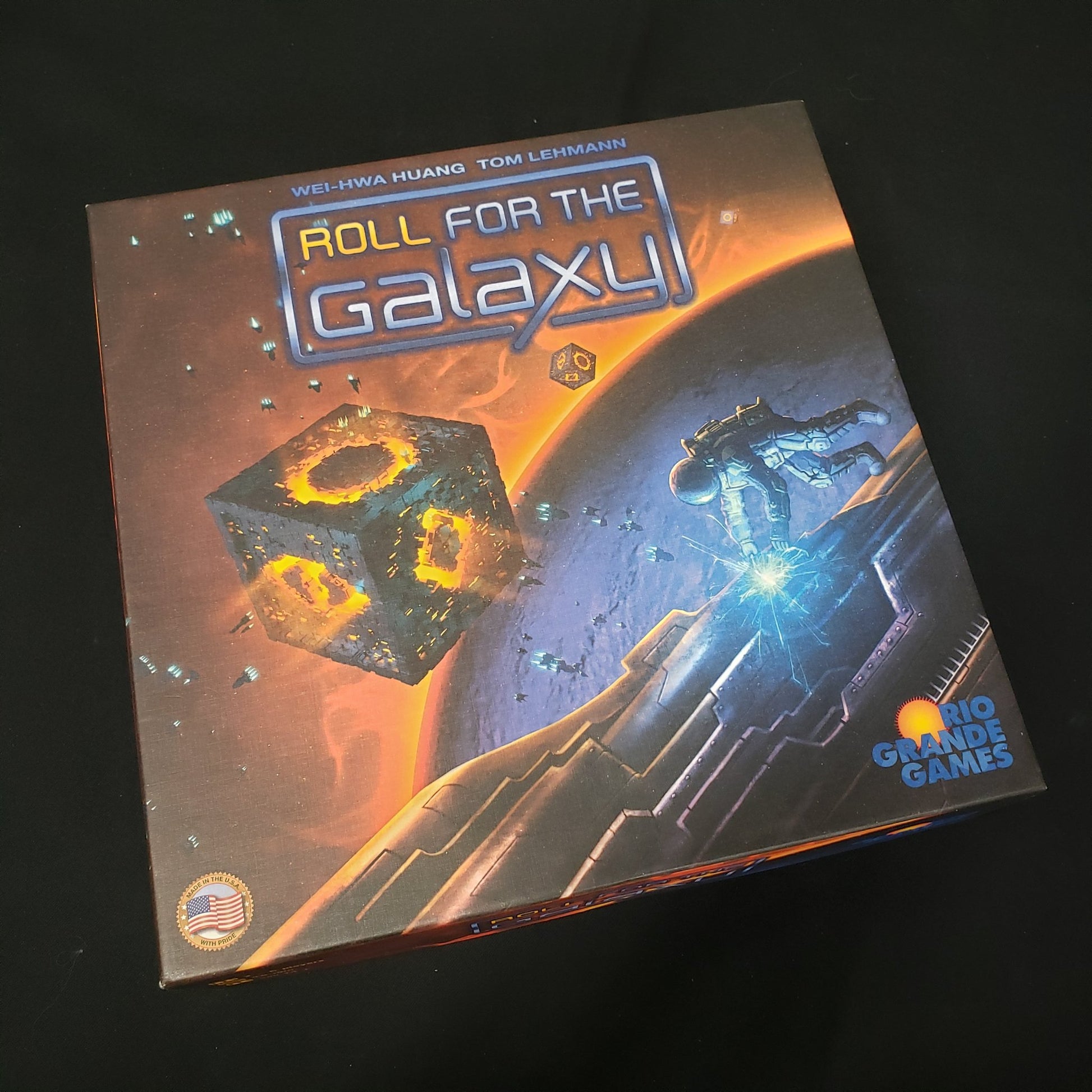 Image shows the front cover of the box of the Roll for the Galaxy board game