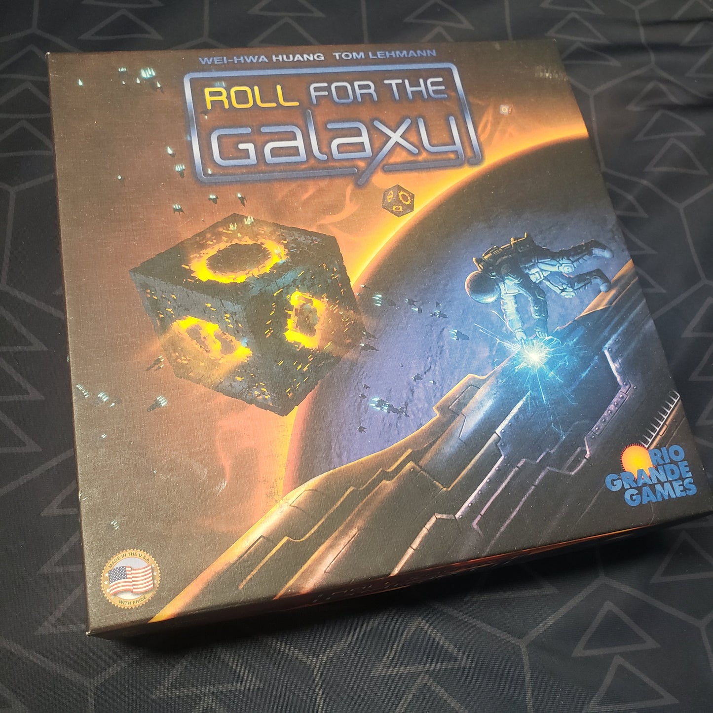 Image shows the front cover of the box of the Roll for the Galaxy board game