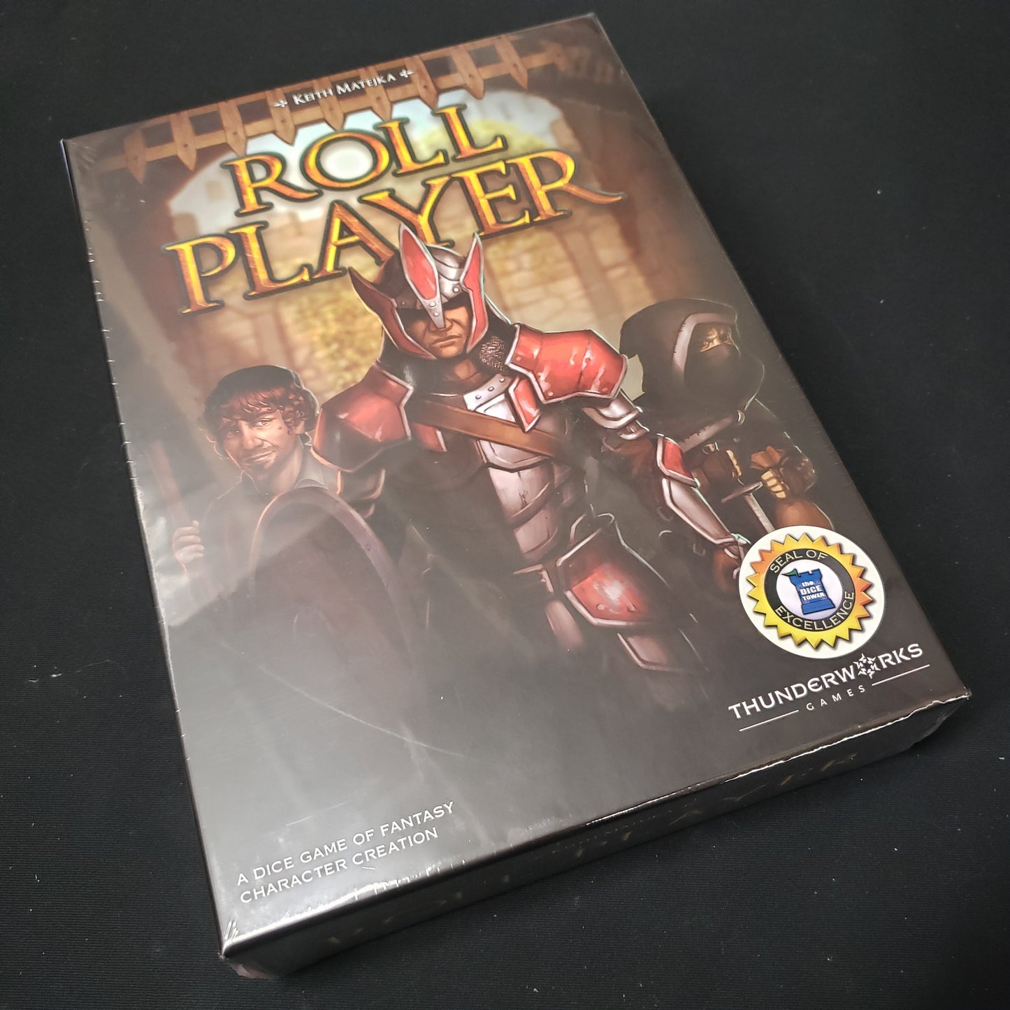 Image shows the front cover of the box of the Roll Player board game