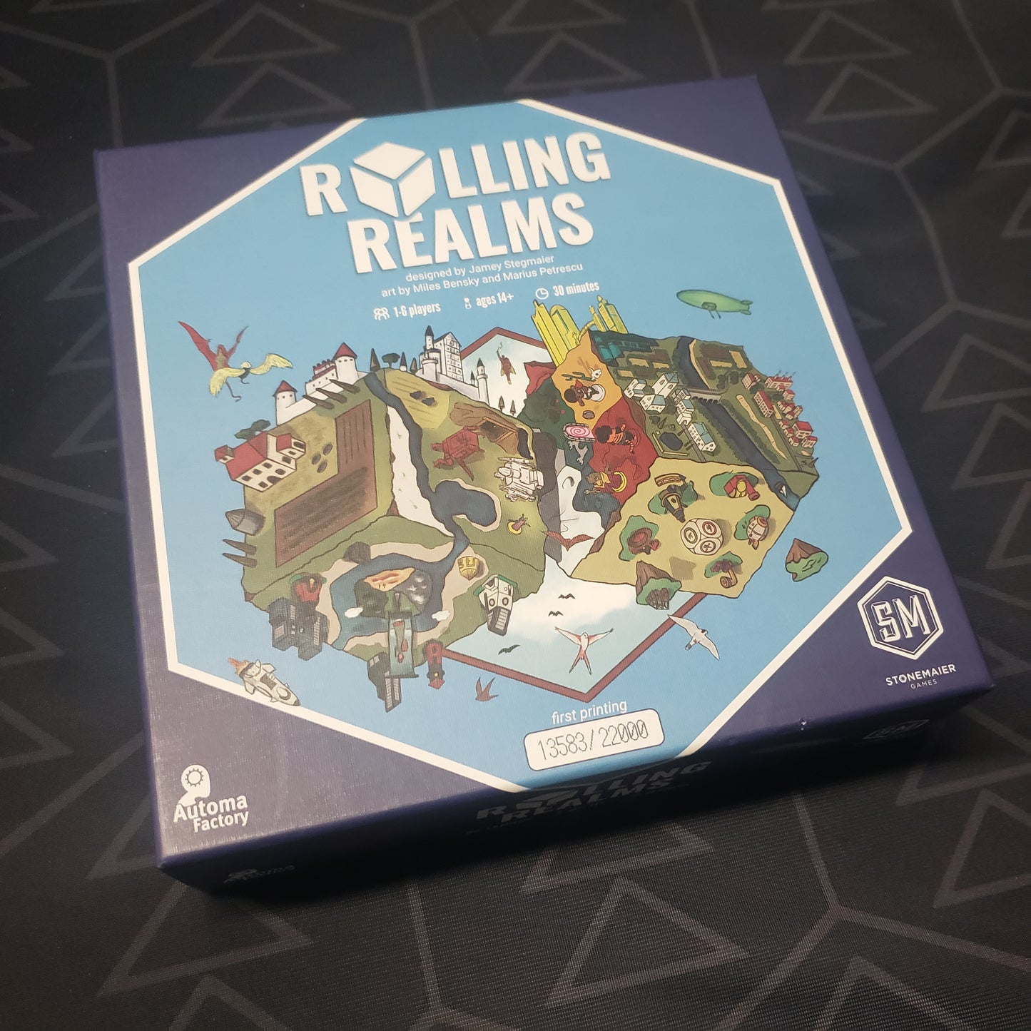 Image shows the front cover of the box of the Rolling Realms board game