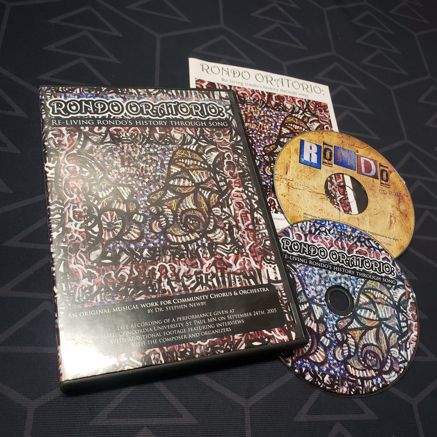 Image shows the case, booklet & two discs for the concert film Rondo Oratorio: Re-Living Rondo's History Through Song on DVD