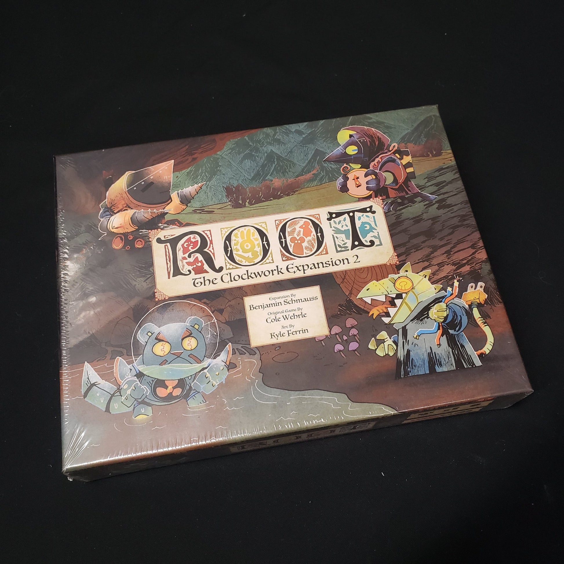 Image shows the front cover of the box for the Clockwork 2 expansion from the board game Root