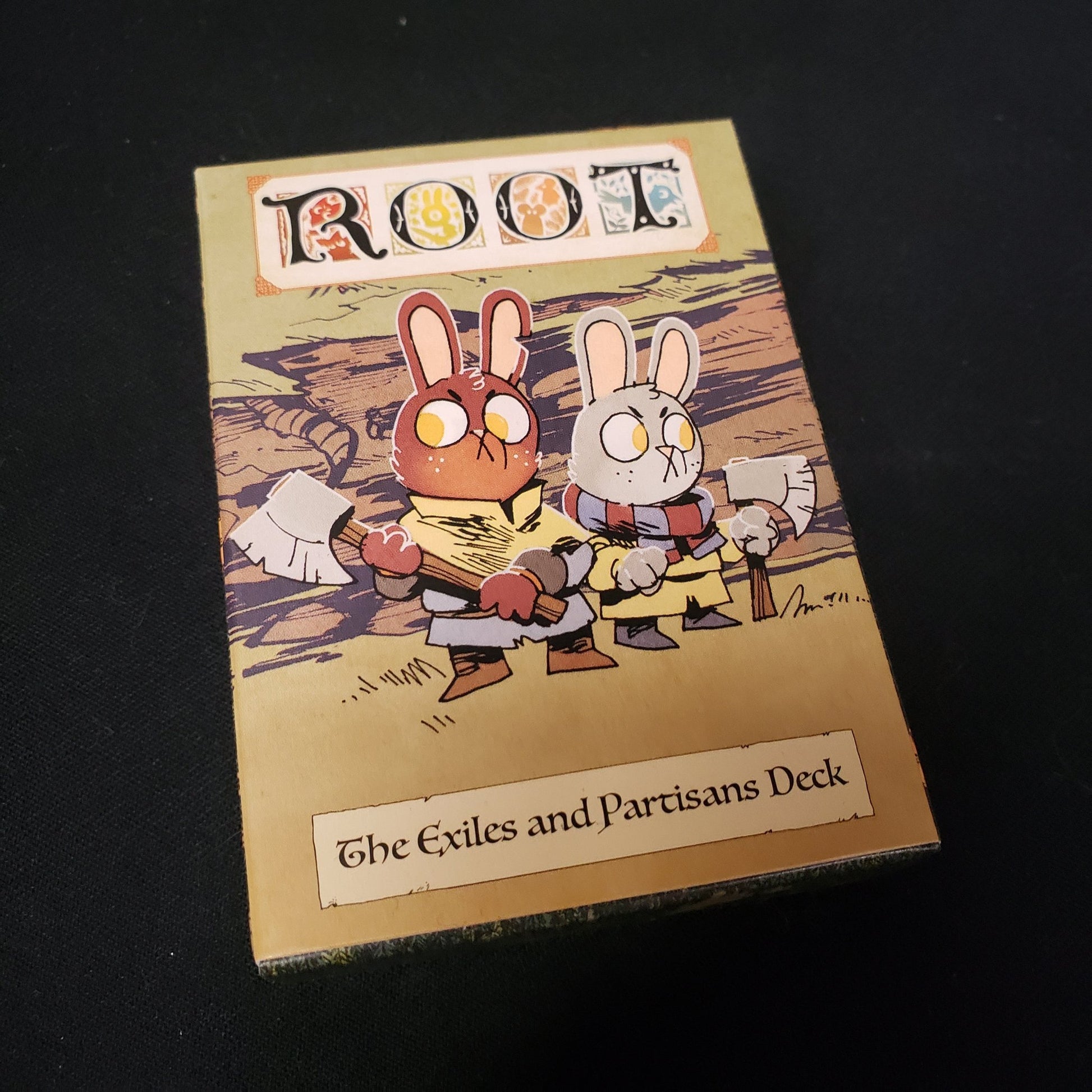 Image shows the front cover of the box for the Exiles & Partisans Deck expansion from the board game Root