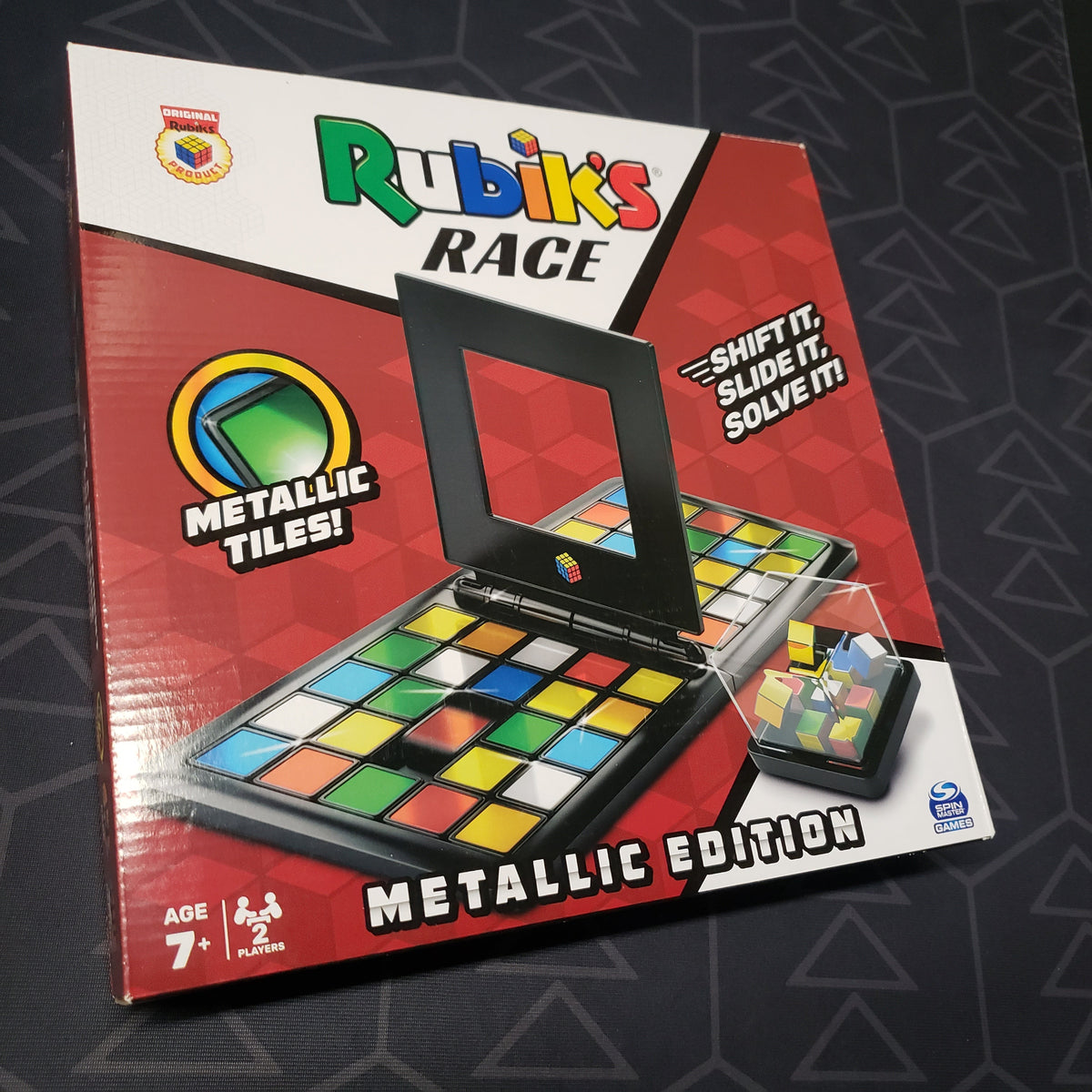 Image shows the front cover of the box for the Rubik's Race (Metallic Edition) board game