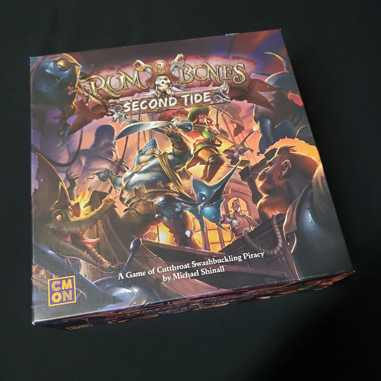 Image shows the front cover of the box of the Rum & Bones: Second Tide board game