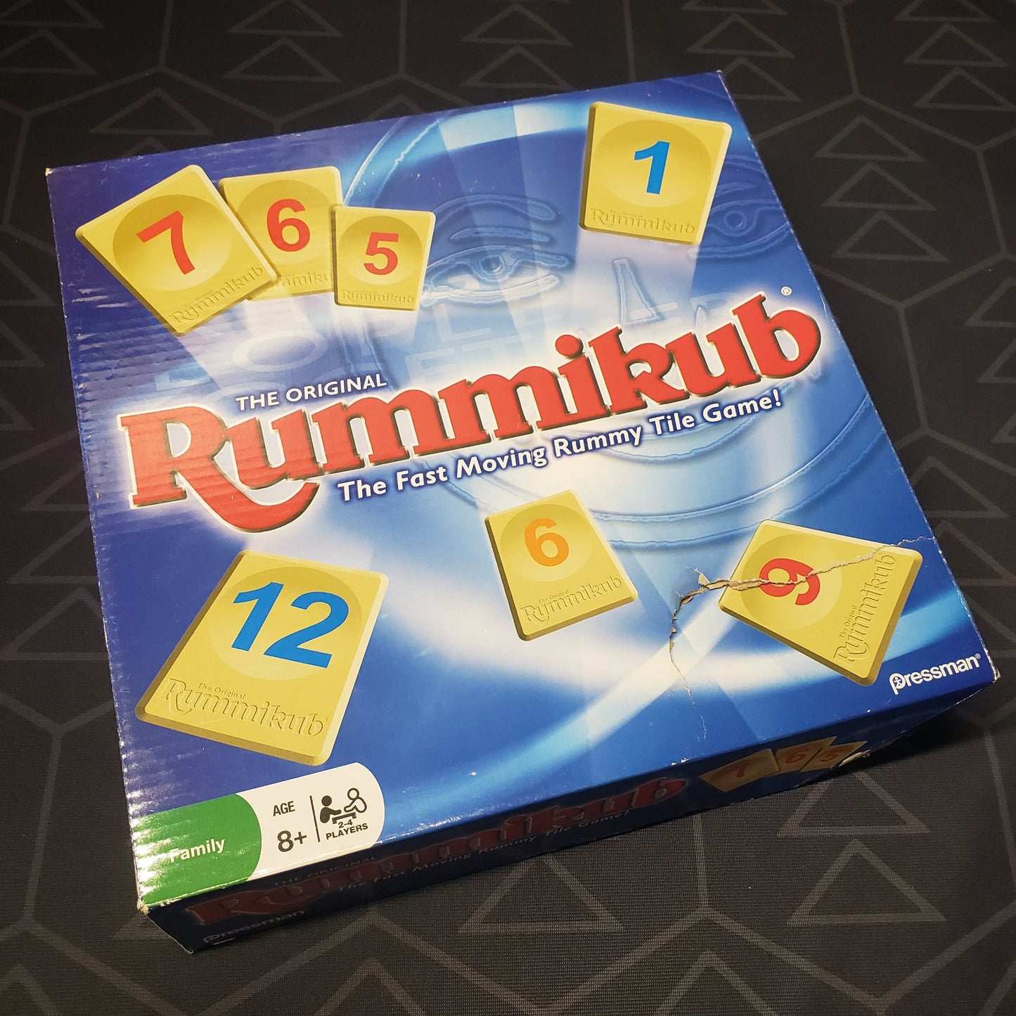 Image shows the front cover of the box for the Rummikub board game