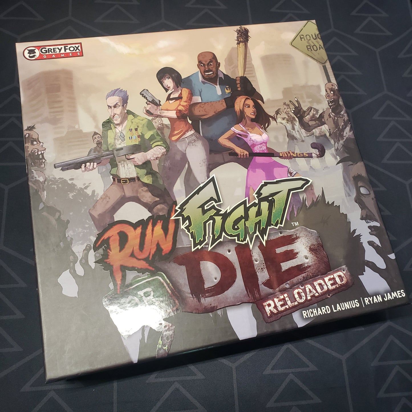 Image shows the front cover of the box of the Run Fight or Die: Reloaded board game