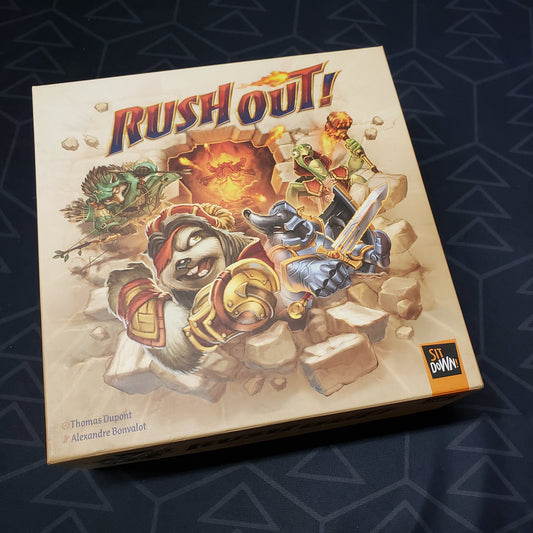 Image shows the front cover of the box for the Rush Out! board game