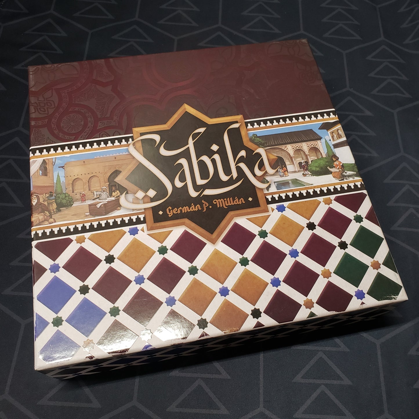 Image shows the front cover of the box of the Sabika board game