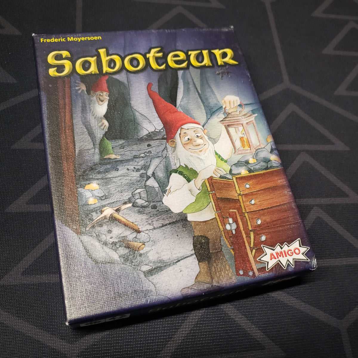 Image shows the front cover of the box of the Saboteur card game