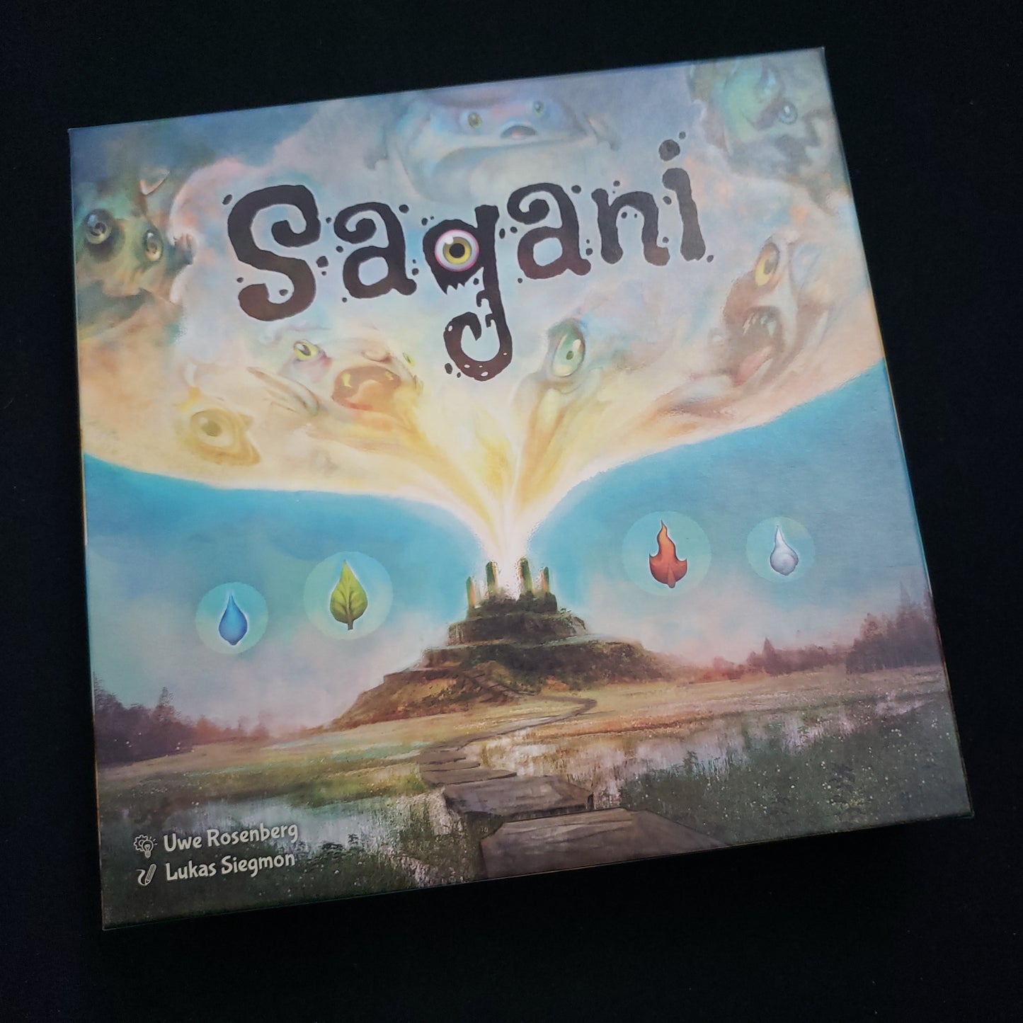 Image shows the front cover of the box of the Sagani board game
