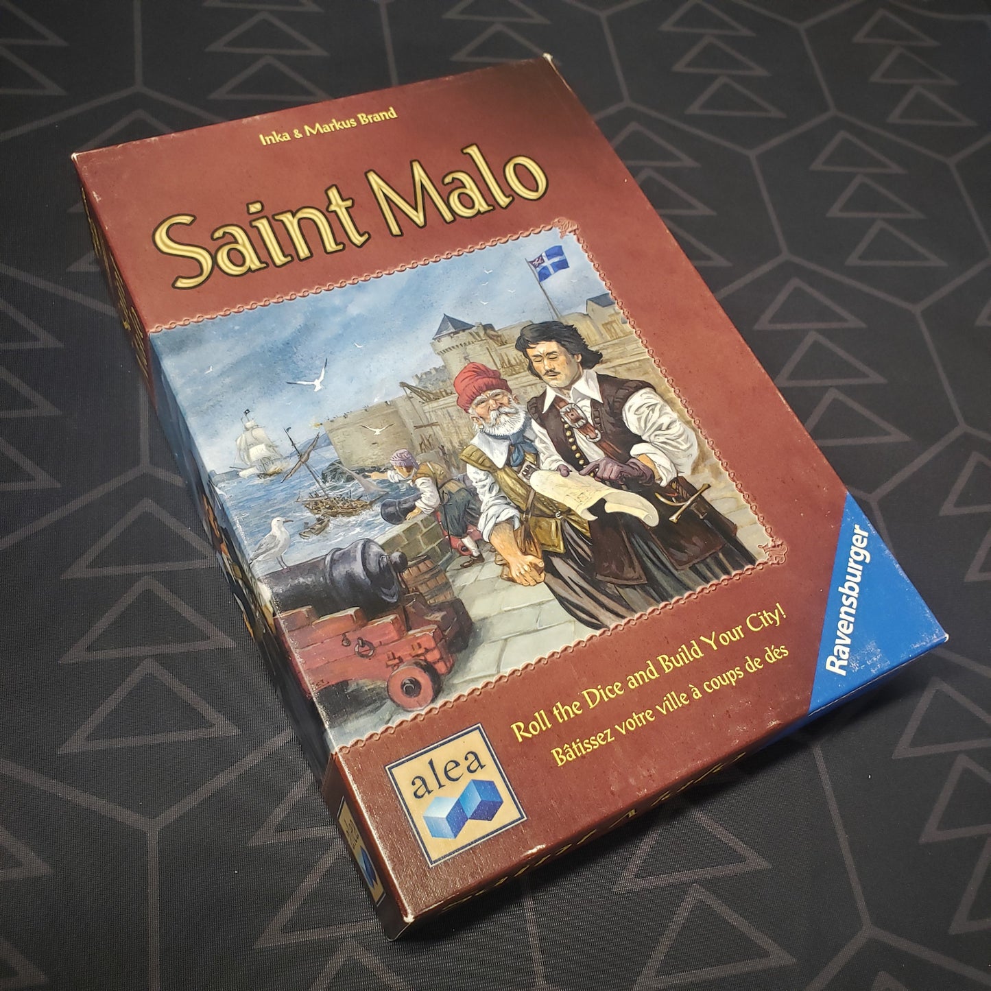 Image shows the front cover of the box for the Saint Malo board game