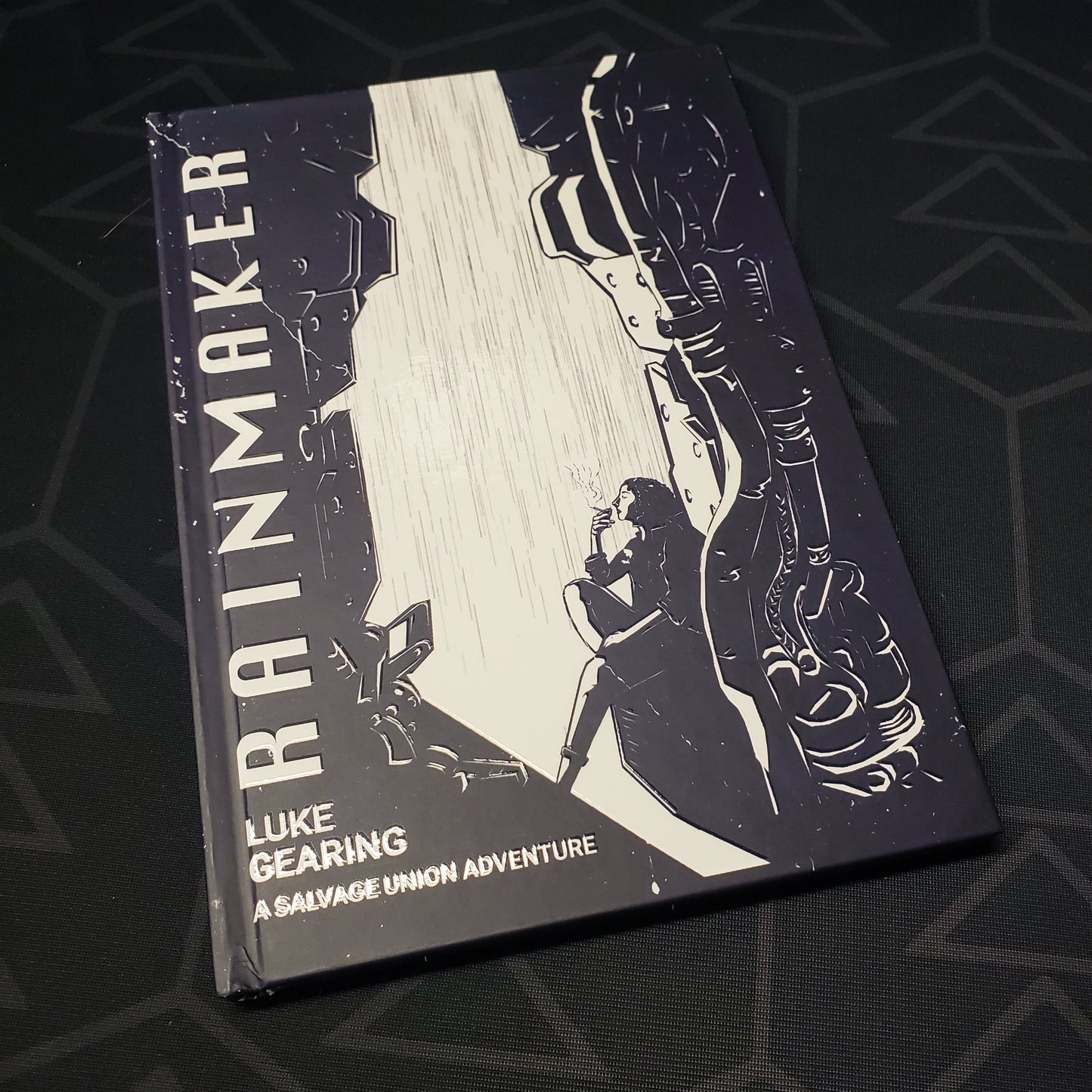 Image shows the front cover of the Rainmaker book for the roleplaying game Salvage Union