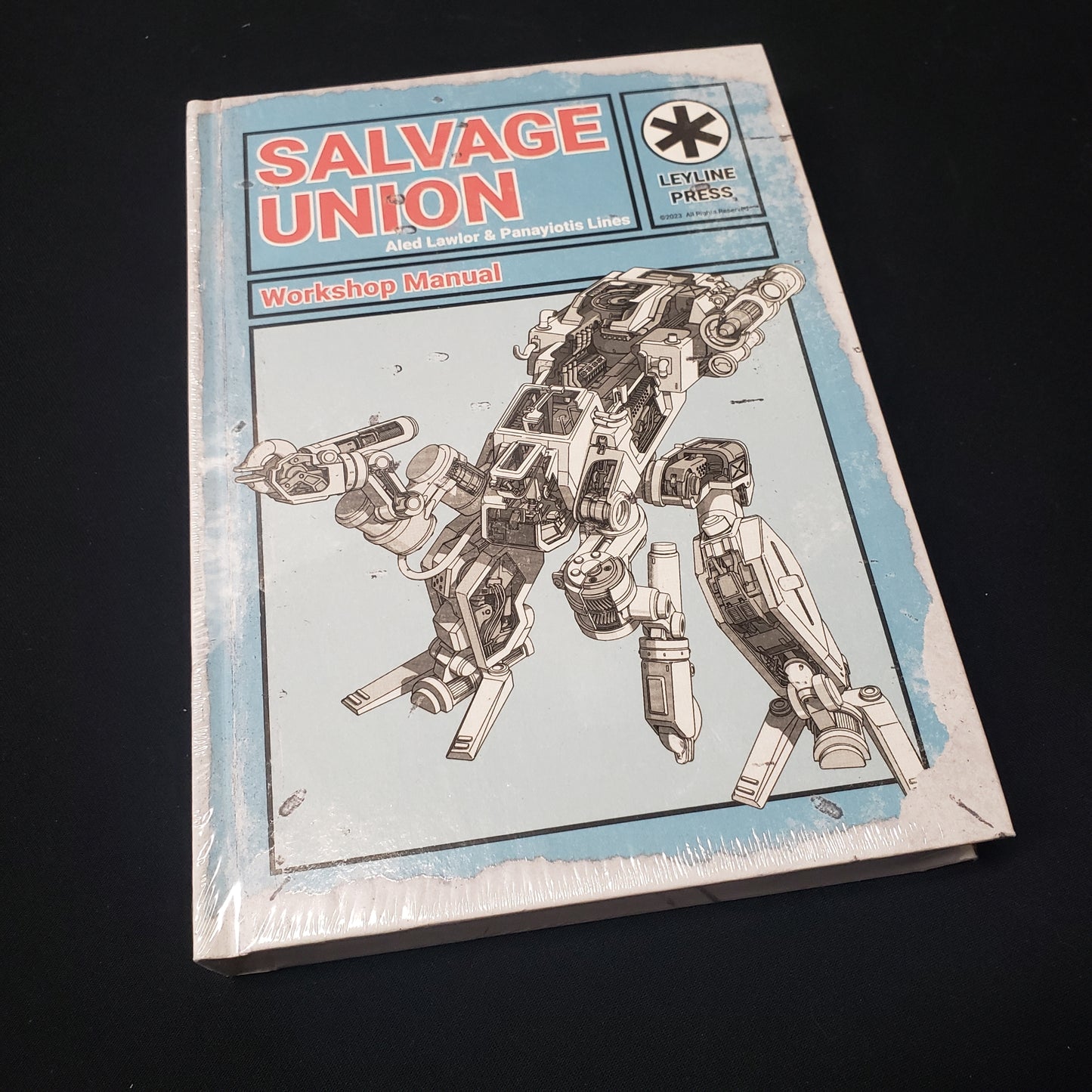 Image shows the front cover of the Workshop Manual book for the Salvage Union roleplaying game