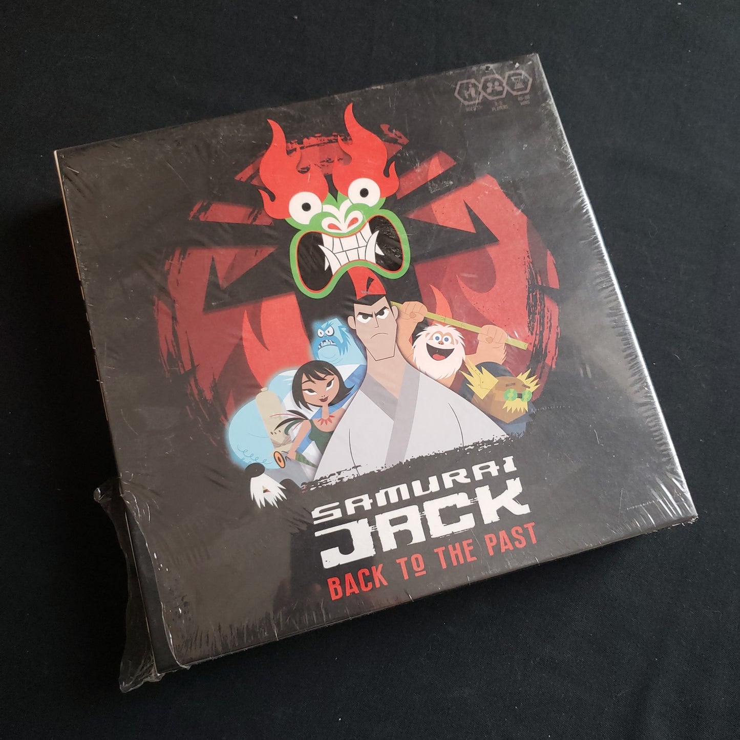 Image shows the front cover of the box of the Samurai Jack: Back to the Past board game