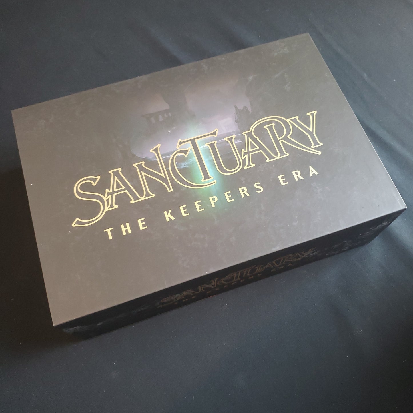 Image shows the front cover of the box of the Sanctuary: The Keepers Era card game