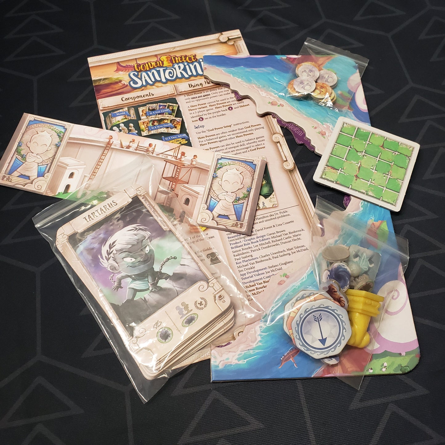 Image shows the instructions and components for the Golden Fleece expansion for the board game Santorini