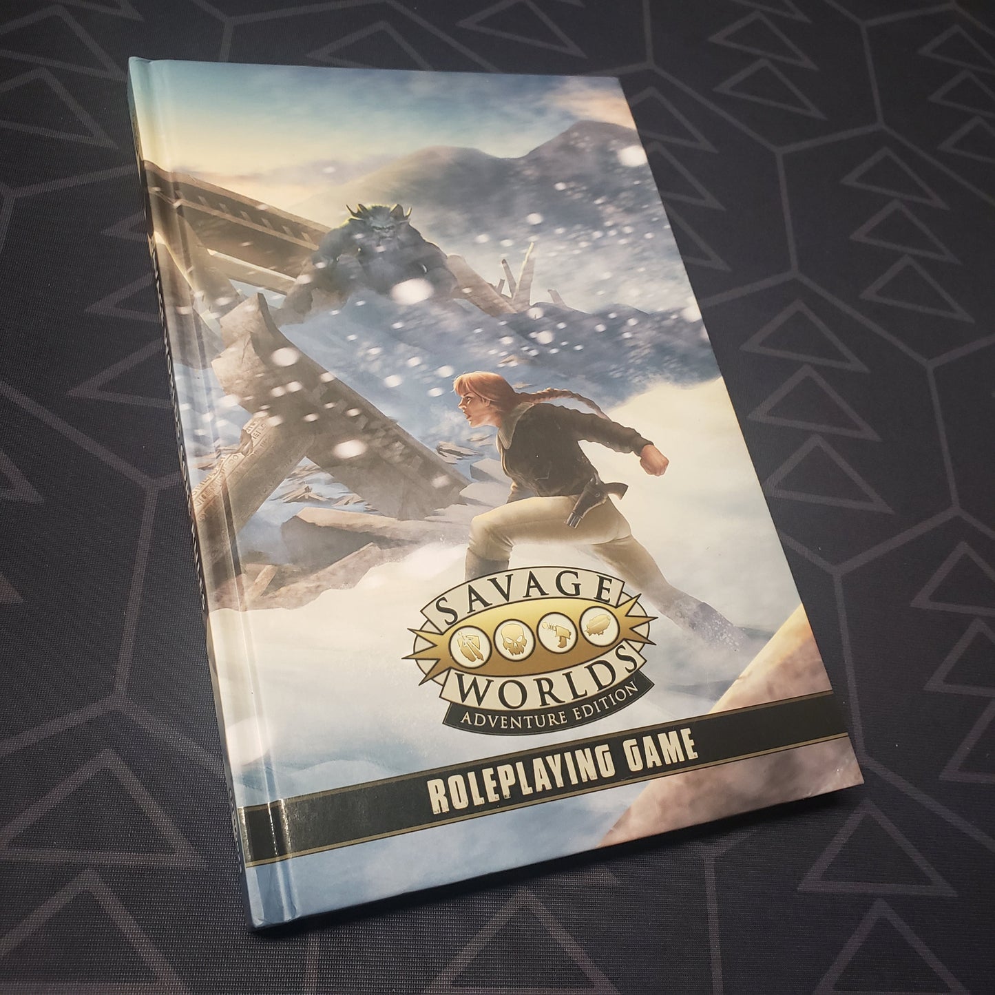 Image shows the front cover of the Adventure Edition Core Rulebook for the roleplaying game Savage Worlds