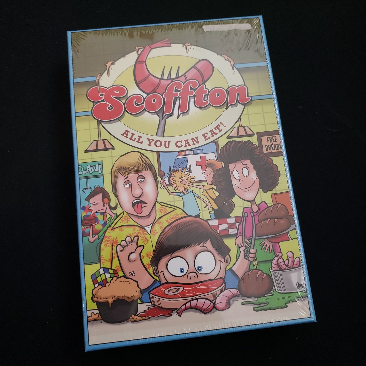 Image shows the front cover of the box of the Scoffton board game
