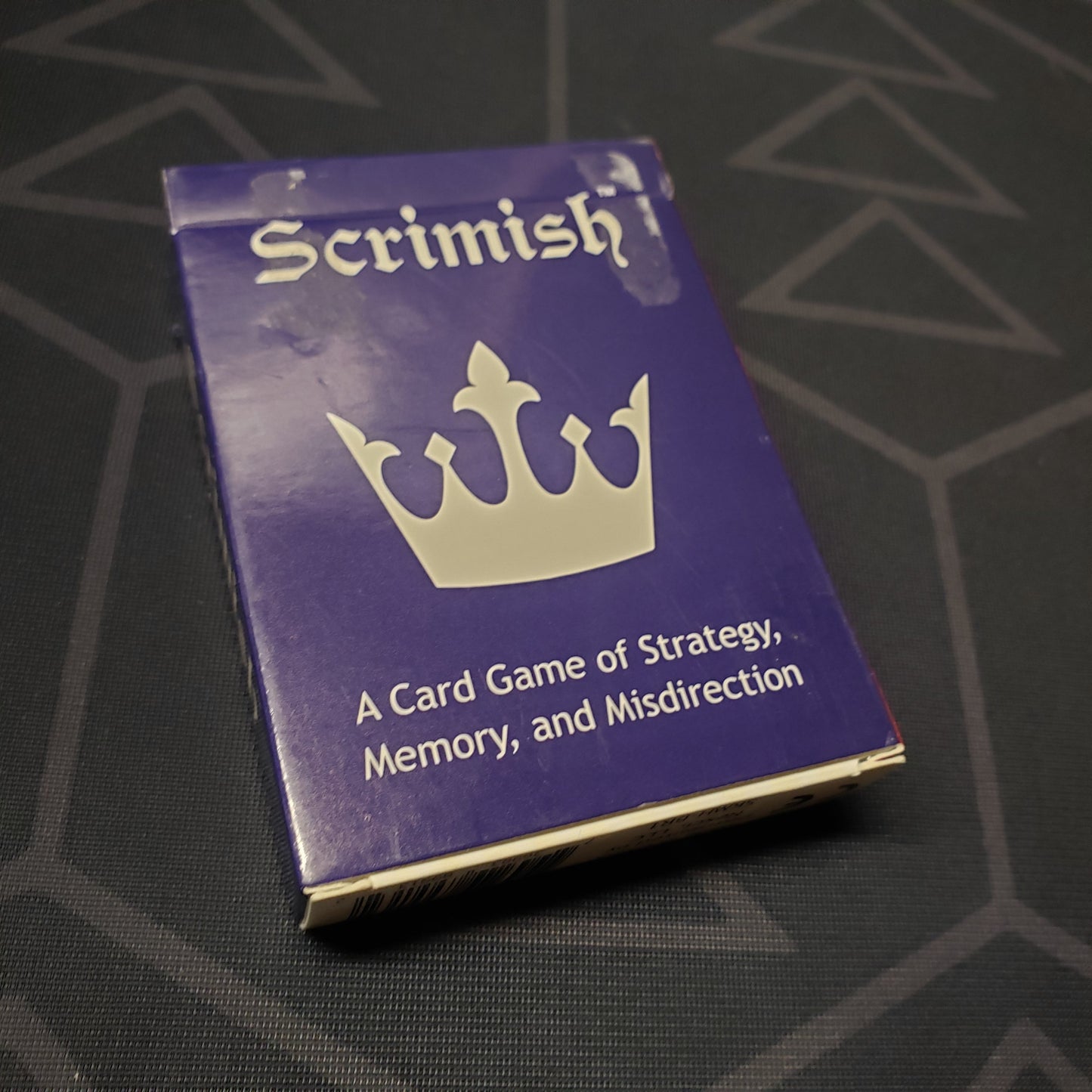 Image shows the front cover of the box for the Scrimish card game