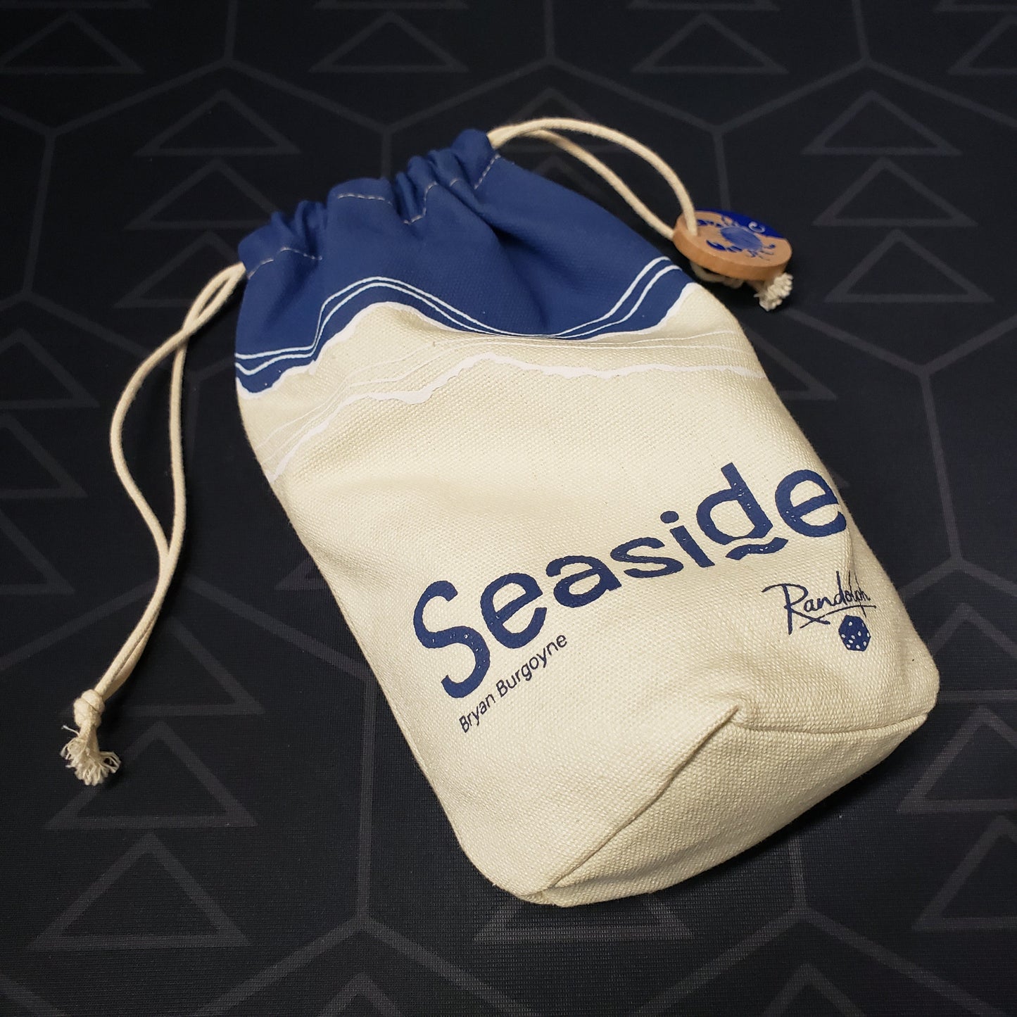 Image shows the drawstring carryong bag of the board game Seaside