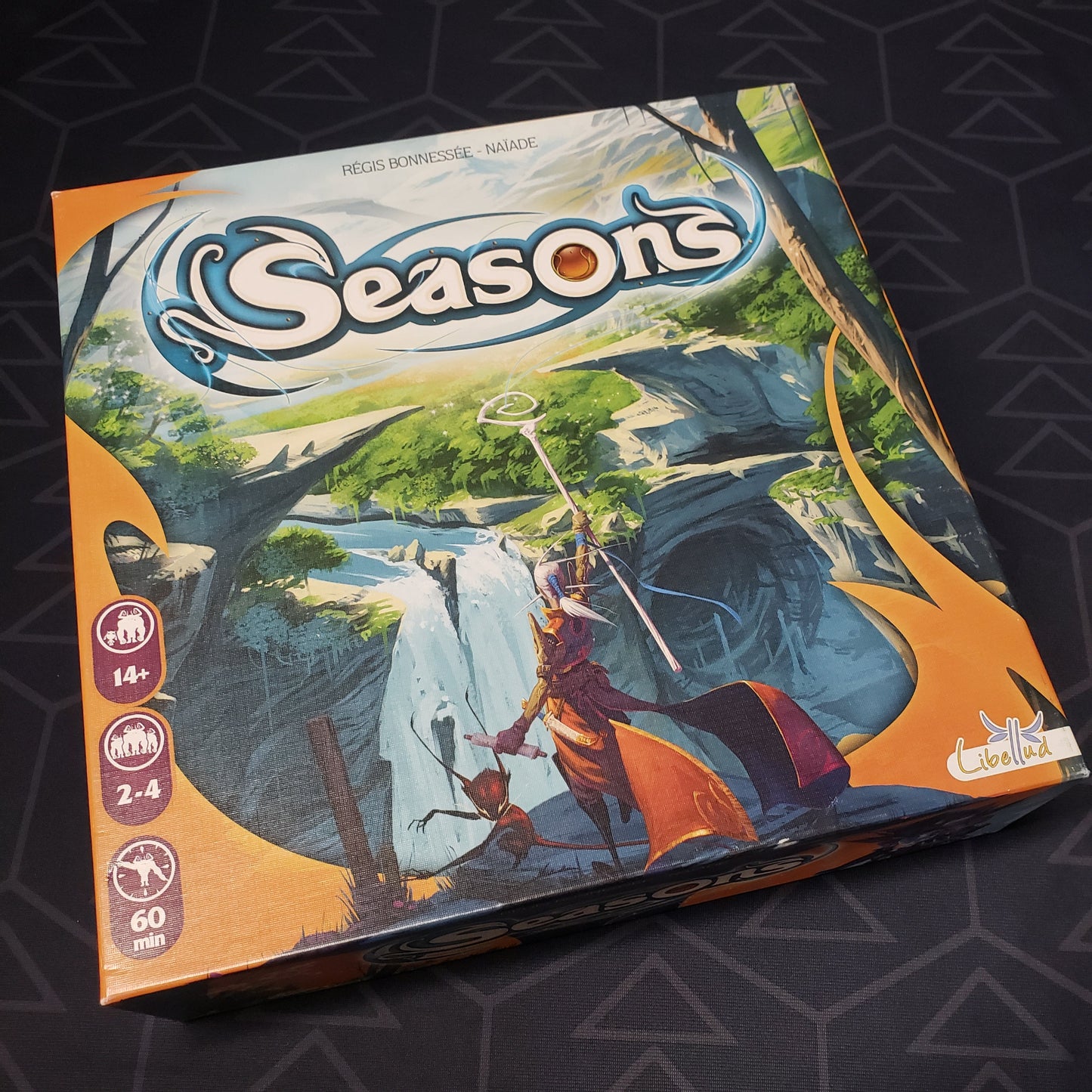 Image shows the front cover of the box of the Seasons card game
