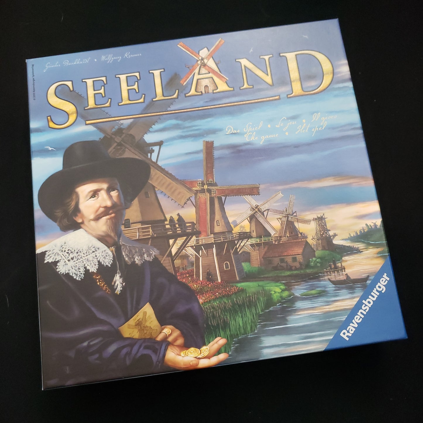 Image shows the front cover of the box of the Seeland board game