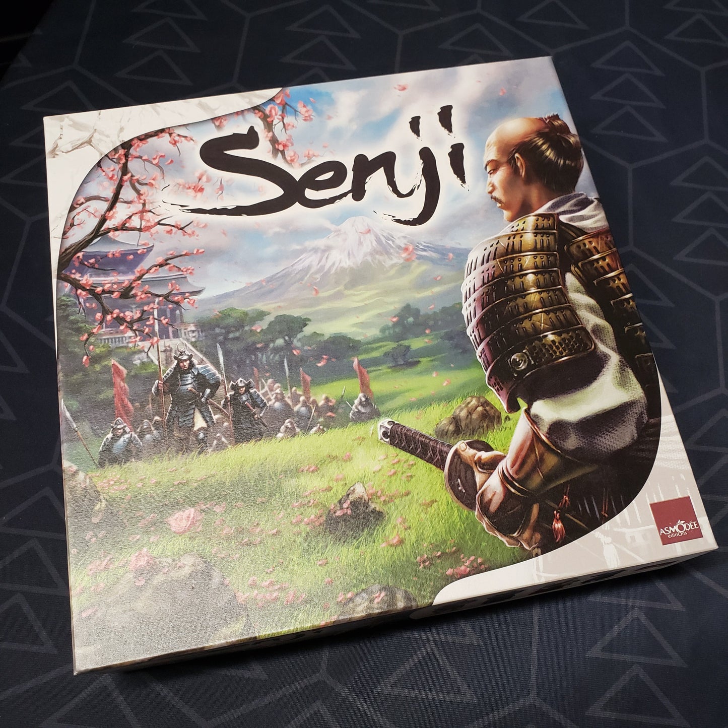 Image shows the front cover of the box for the Senji board game