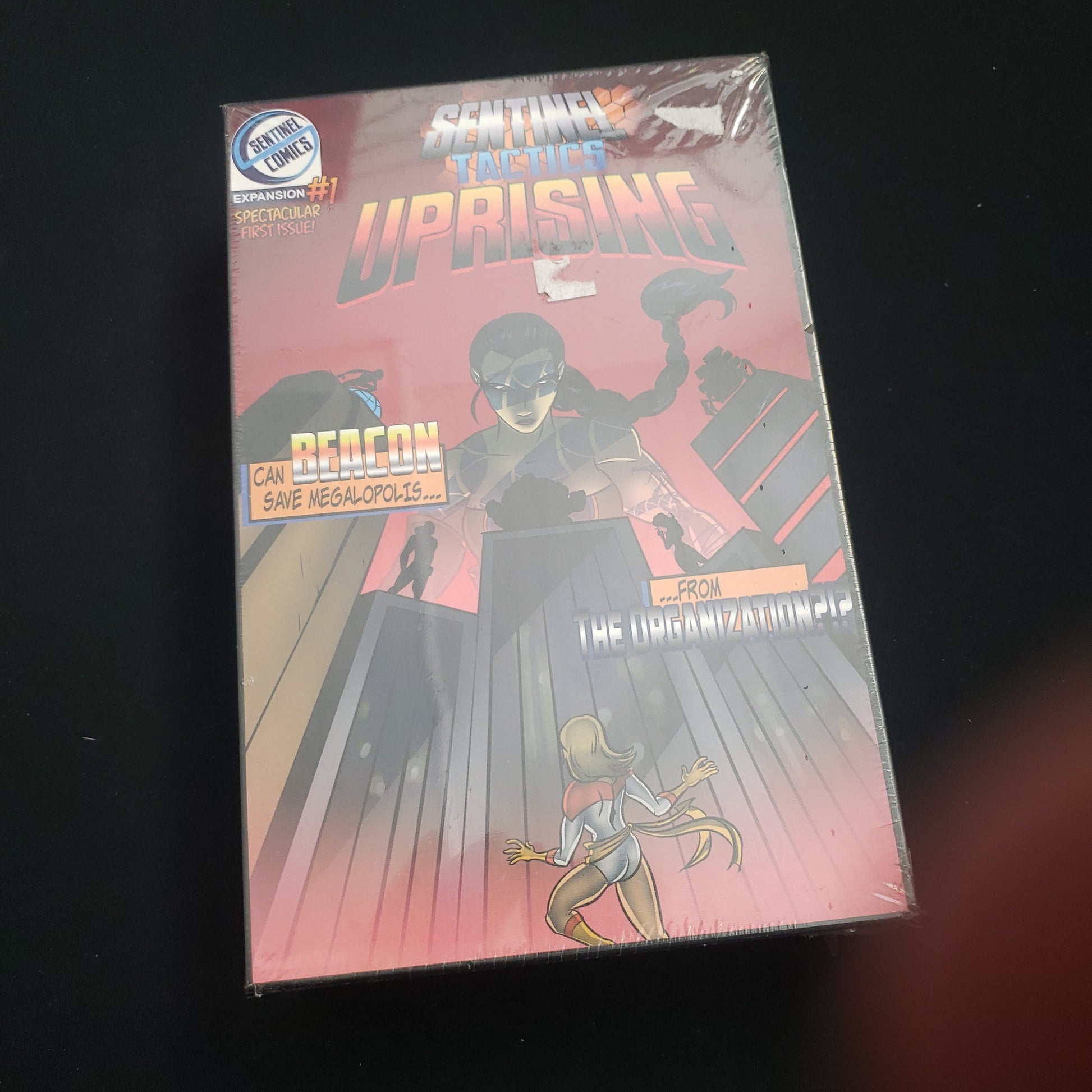 Image shows the front cover of the box of the Uprising expansion for the board game Sentinel Tactics
