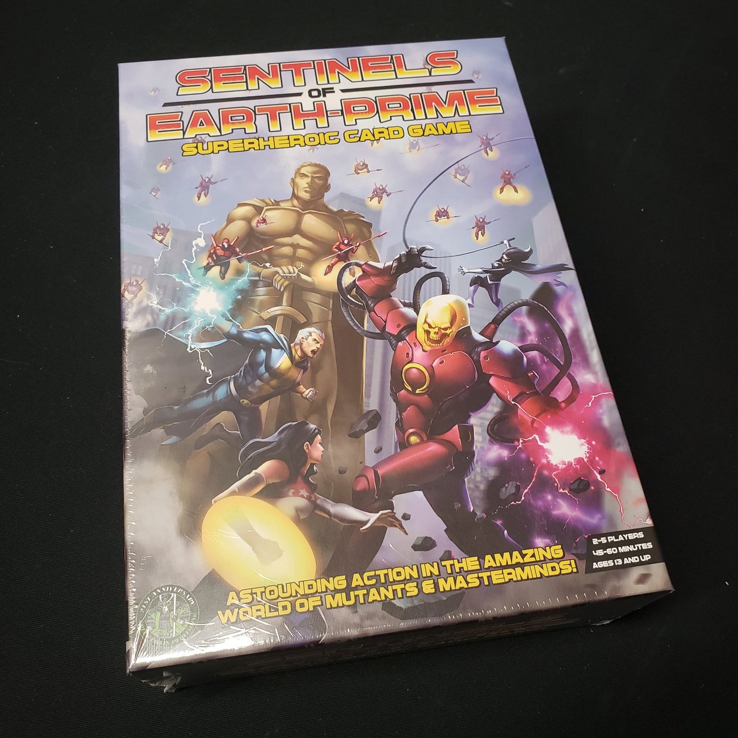Image shows the front cover of the box of the Sentinels of Earth-Prime card game