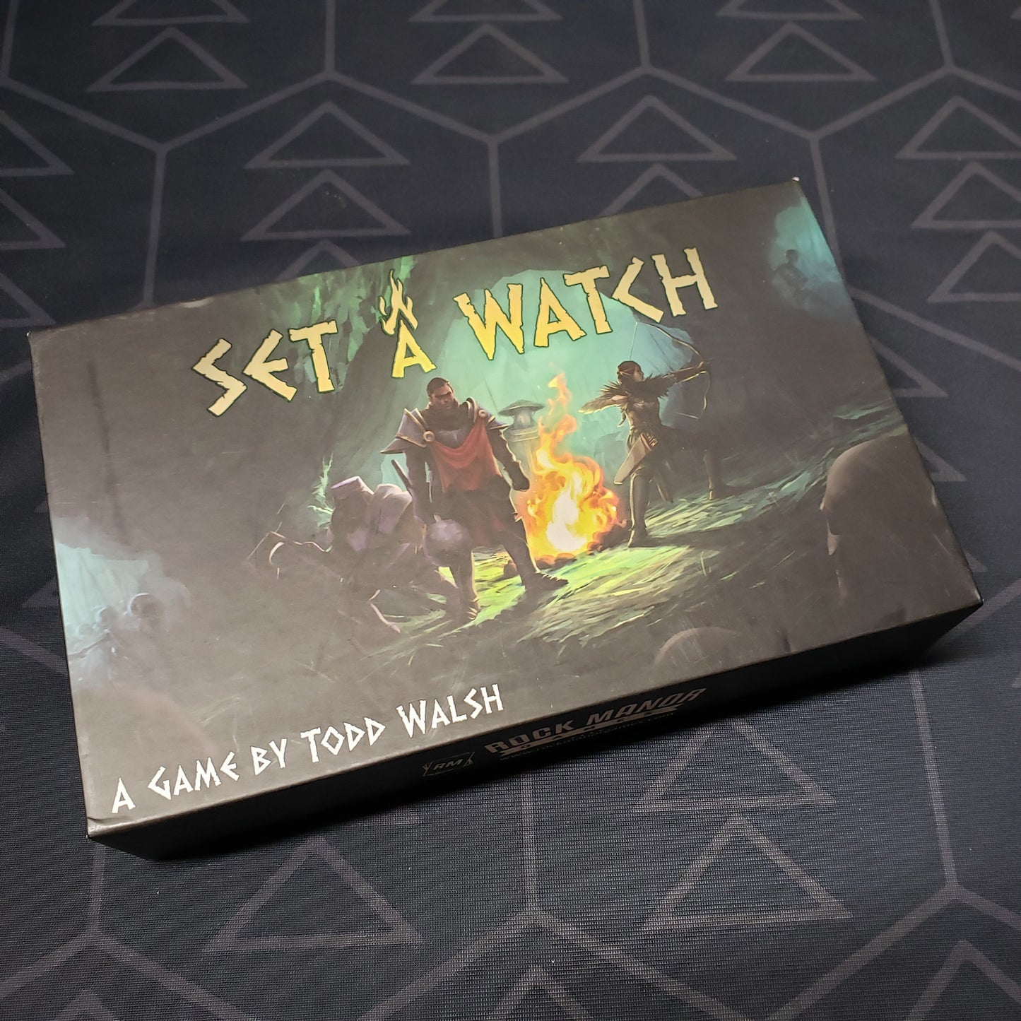 Image shows the front cover of the box of the Set A Watch board game