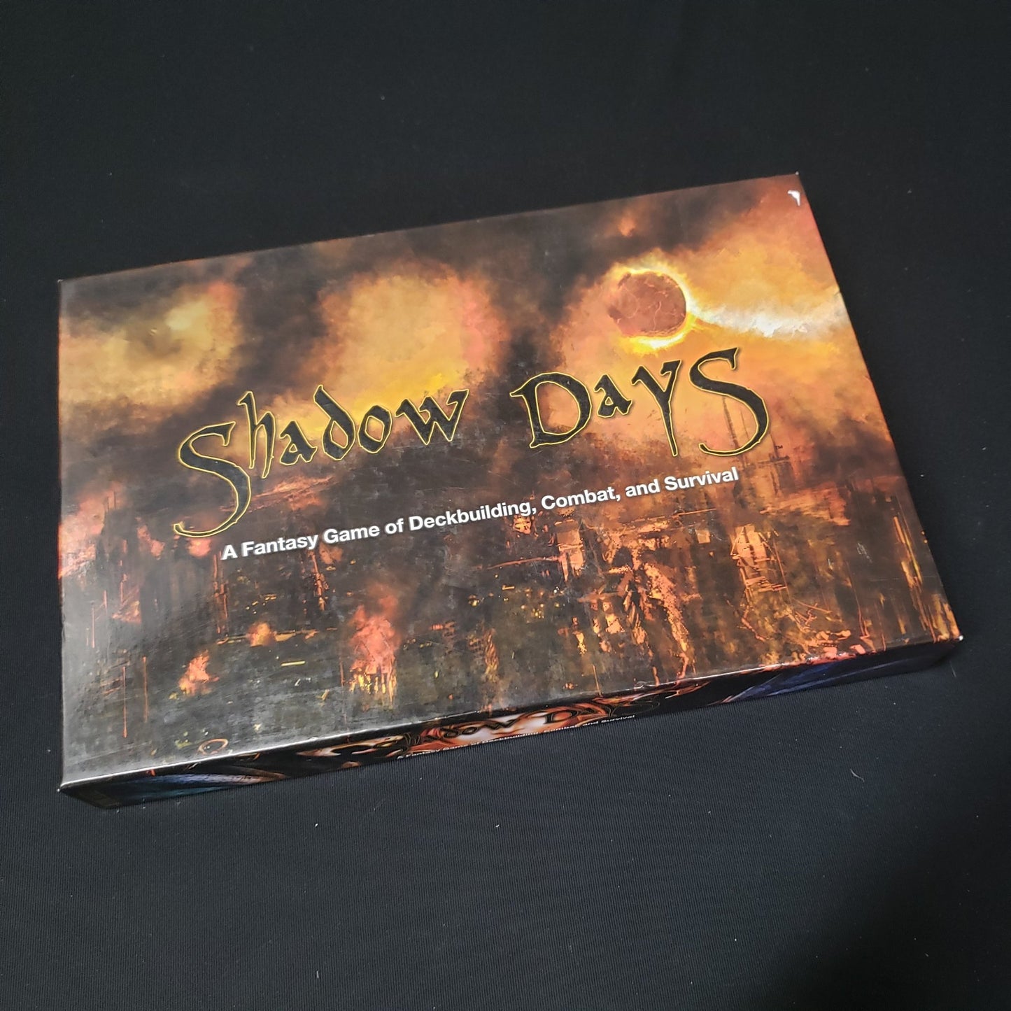 Image shows the front cover of the box of the Shadow Days card game