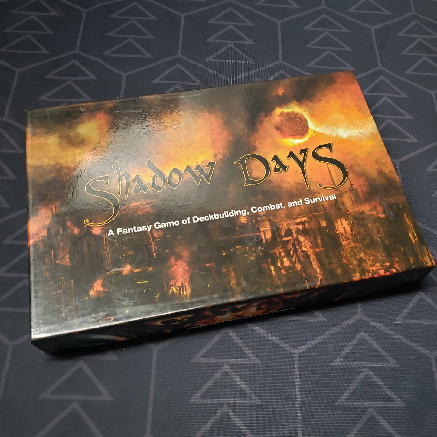 Image shows the front cover of the box of the Shadow Days card game