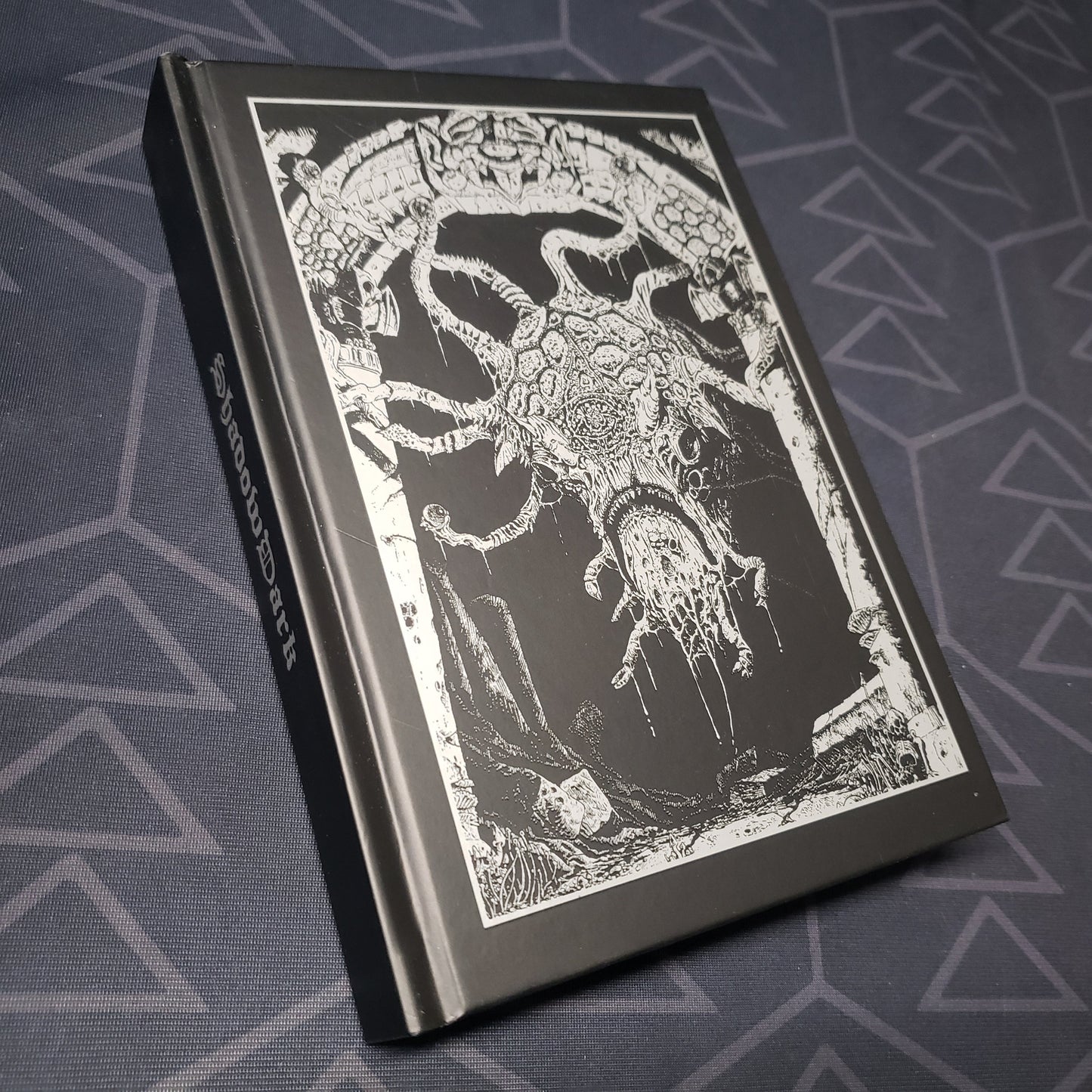 Image shows the front cover of the core rulebook for the roleplaying game Shadowdark