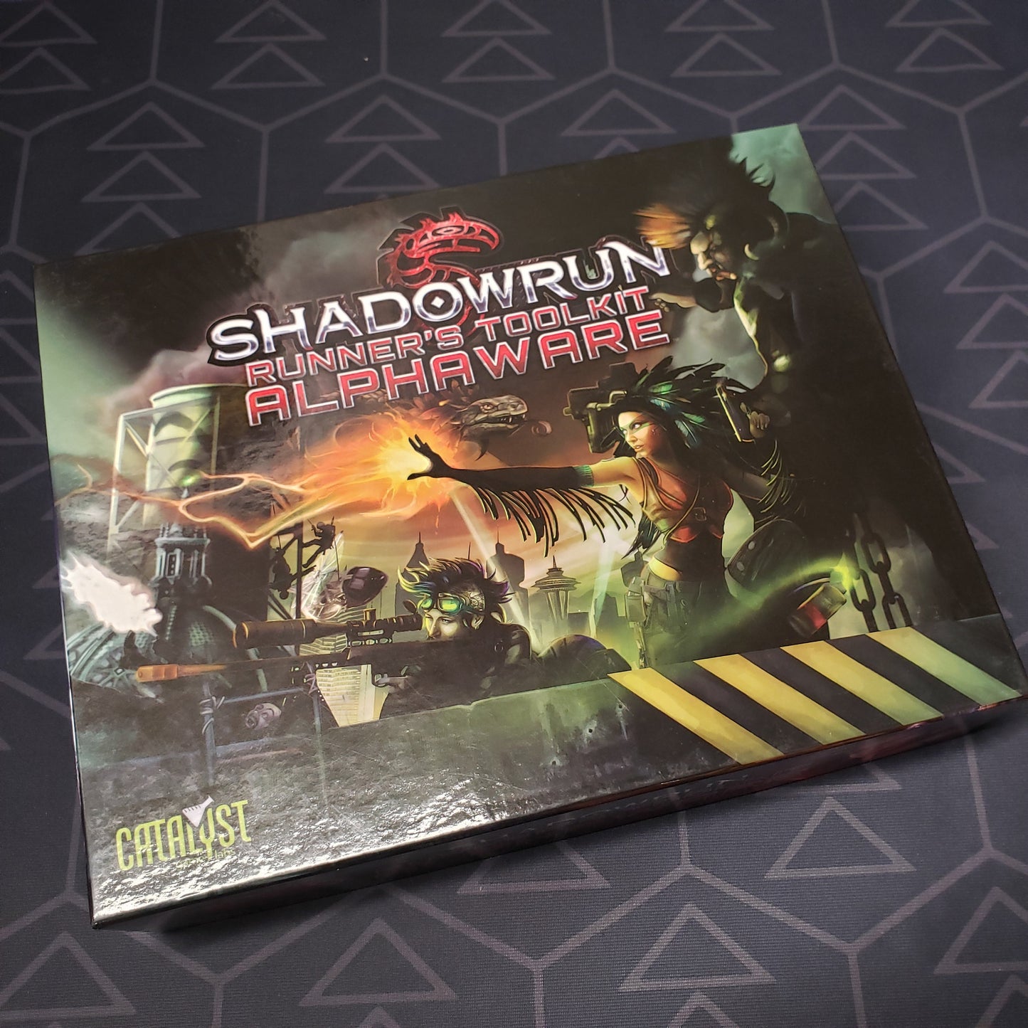 Image shows the front cover of the Runner's Toolkit: Alphaware box for the roleplaying game Shadowrun 5E