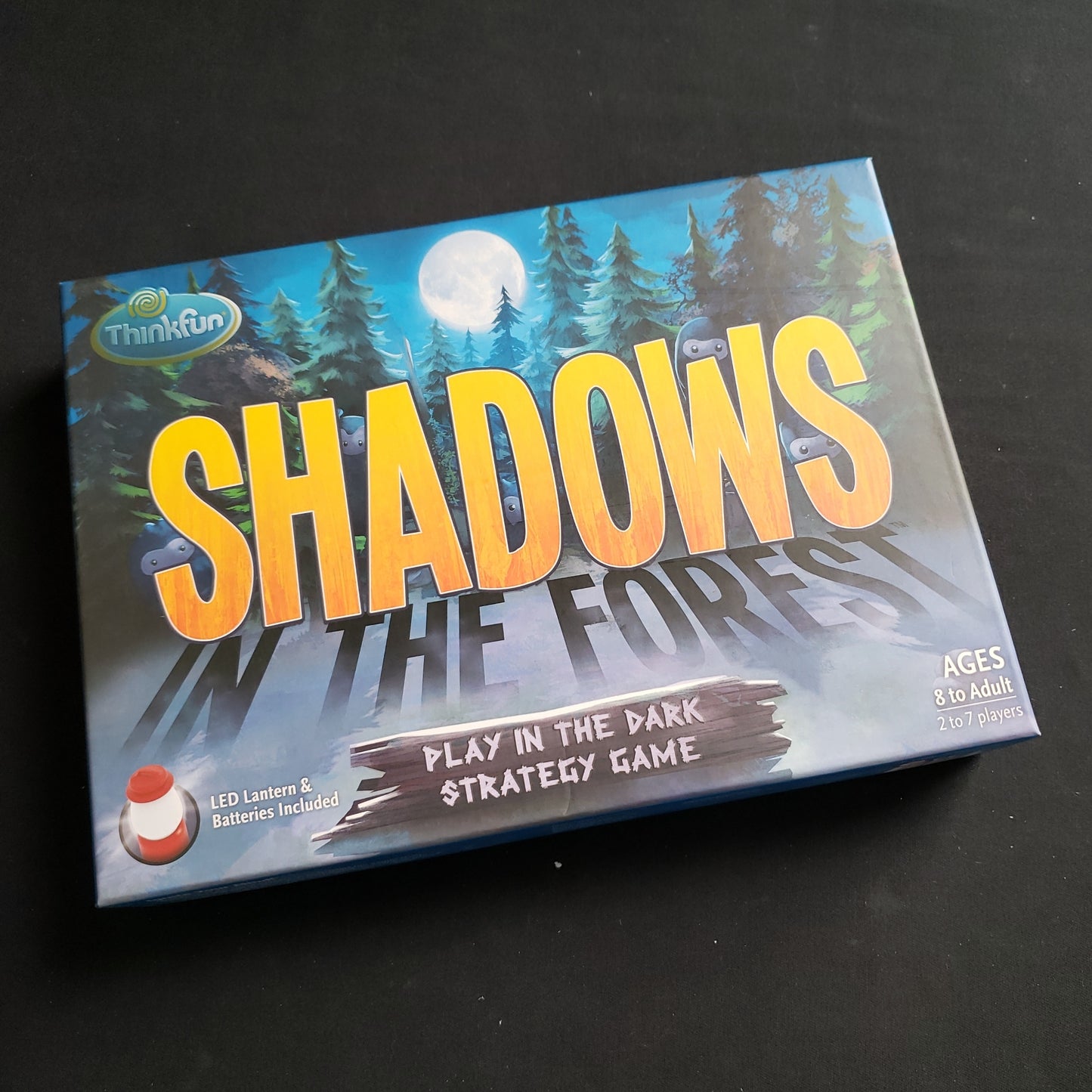 Image shows the front cover of the box of the Shadows in the Forest board game