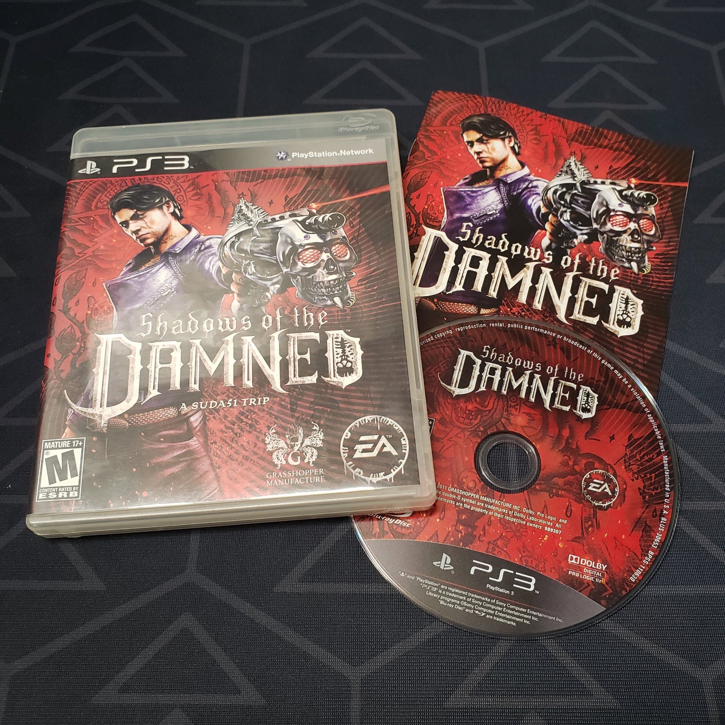 Image shows the case, manual and disc for the video game Shadows of the Damned for Playstation 3